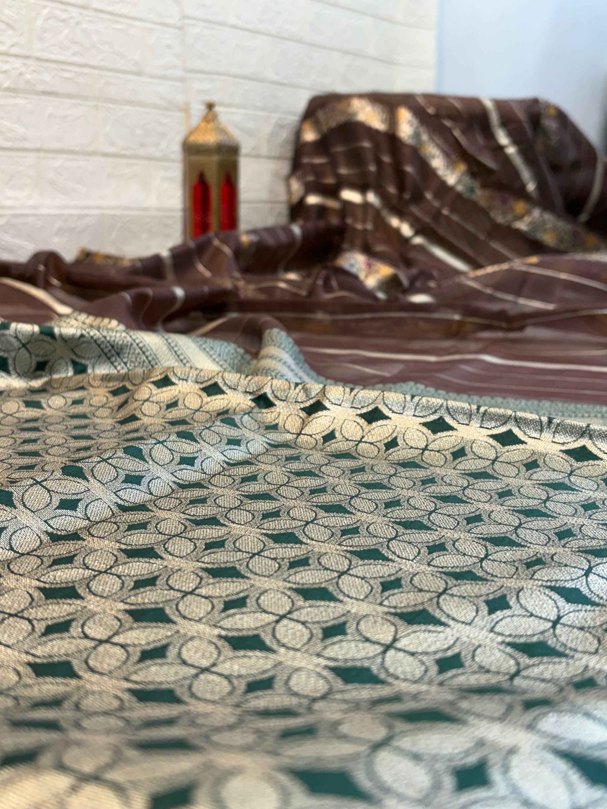 Dark brown zari Elegance Premium soft cotton saree with subtle zari stripes, floral butti accents, and a richly woven antique gold zari pallu and border for a classic, graceful look.