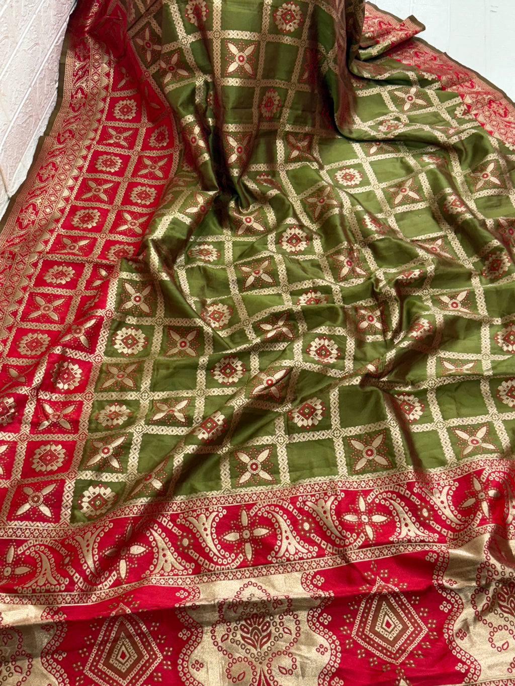 Name: Olive green Saree
Fabric: Pure Art silk blend adorned with traditional block print motifs and a contrasting red border for a timeless ethnic appeal.