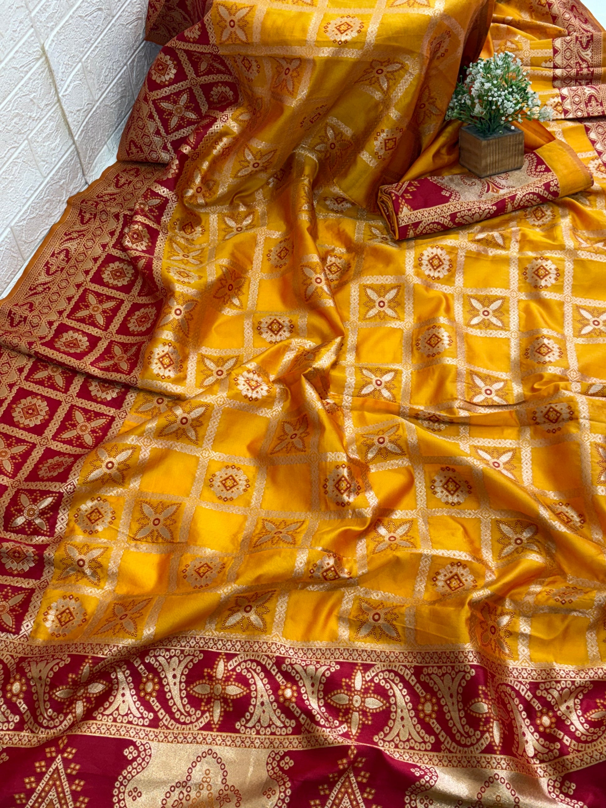 This appears to be a Mustard Yellow Silk Blend or Art Silk Saree/Fabric featuring intricate Zari woven work. The design is a geometric grid or check pattern enclosing distinct floral and circular motifs.