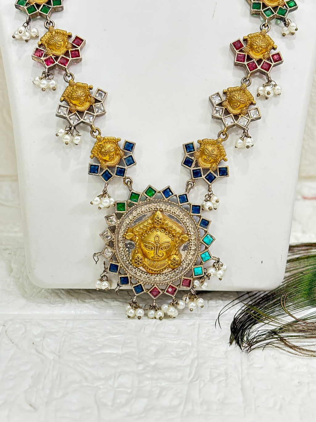 Name: Navrang Devi Haar
Collection: Shaktiya Collection – A divine temple-inspired jewellery line featuring goddess motifs, multicolour stones, and delicate pearl drops, perfect for festive and traditional occasions.