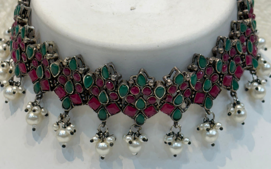 Name: Traditional Kundan Choker Necklace Set Oxidized silver metal with red-green stone inlay and silver bead drops
