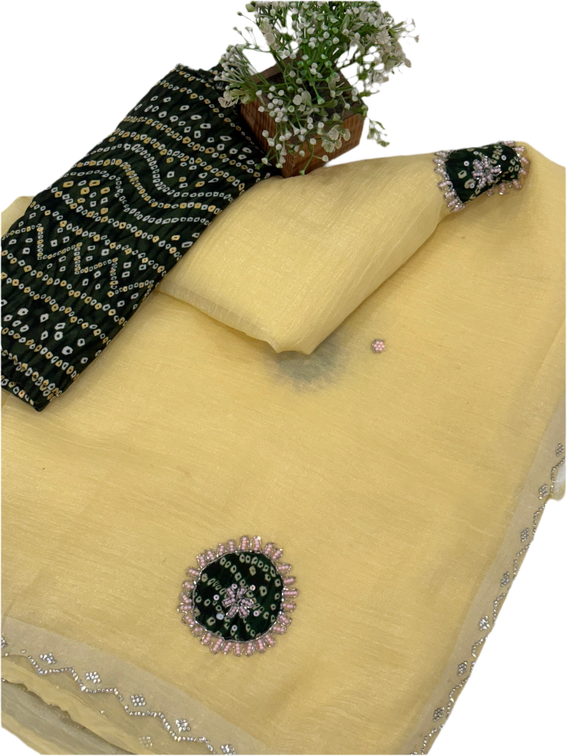 Light yellow crepe Saree with a sheer, lightweight fabric forest green Bandhani print blouse base embellished with sequins and embroidery butas.