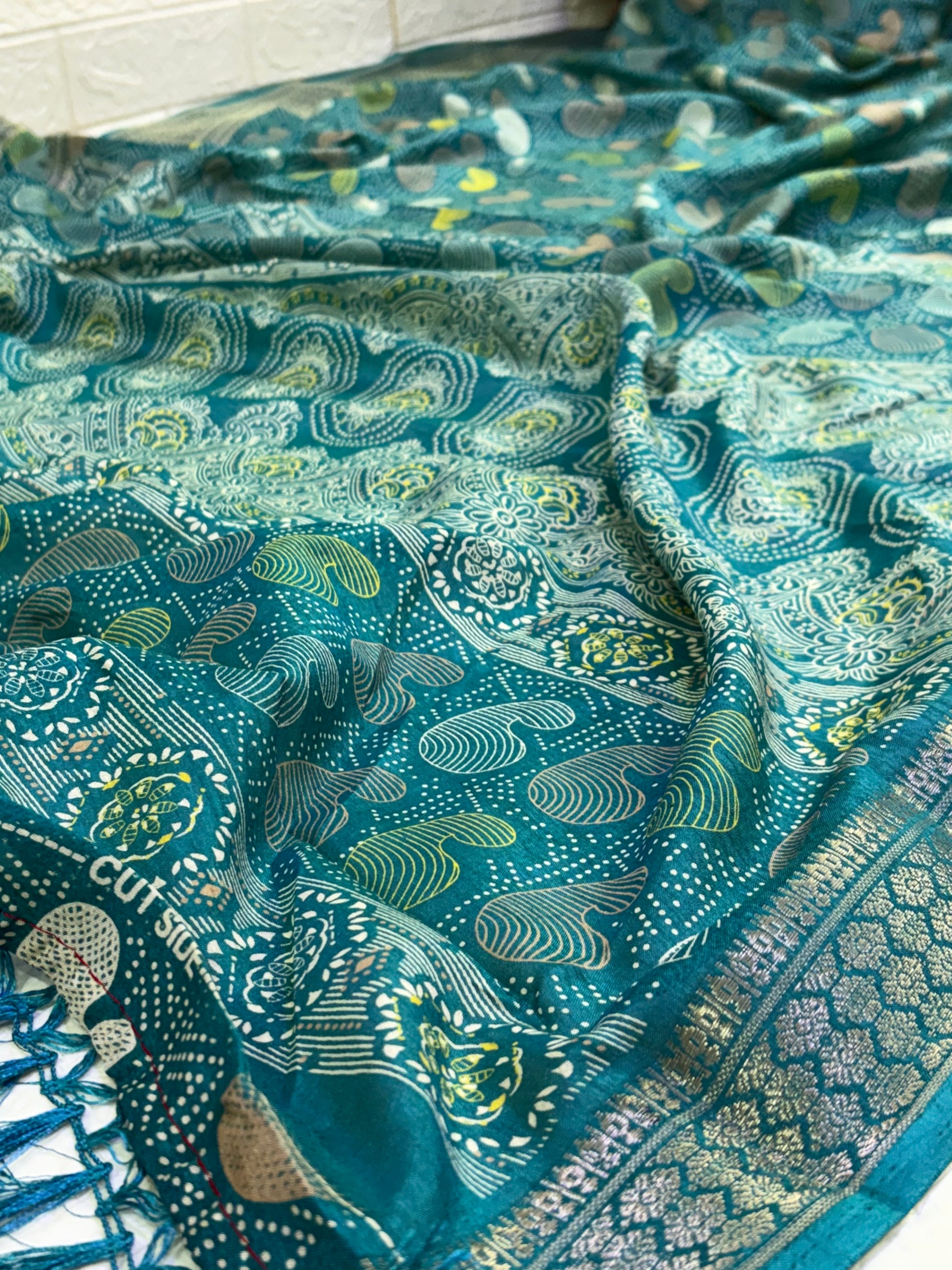 Name: Teal colour Saree
Fabric: cotton silk featuring intricate zari weaves and multicolor paisley motifs, blending tradition with elegance.