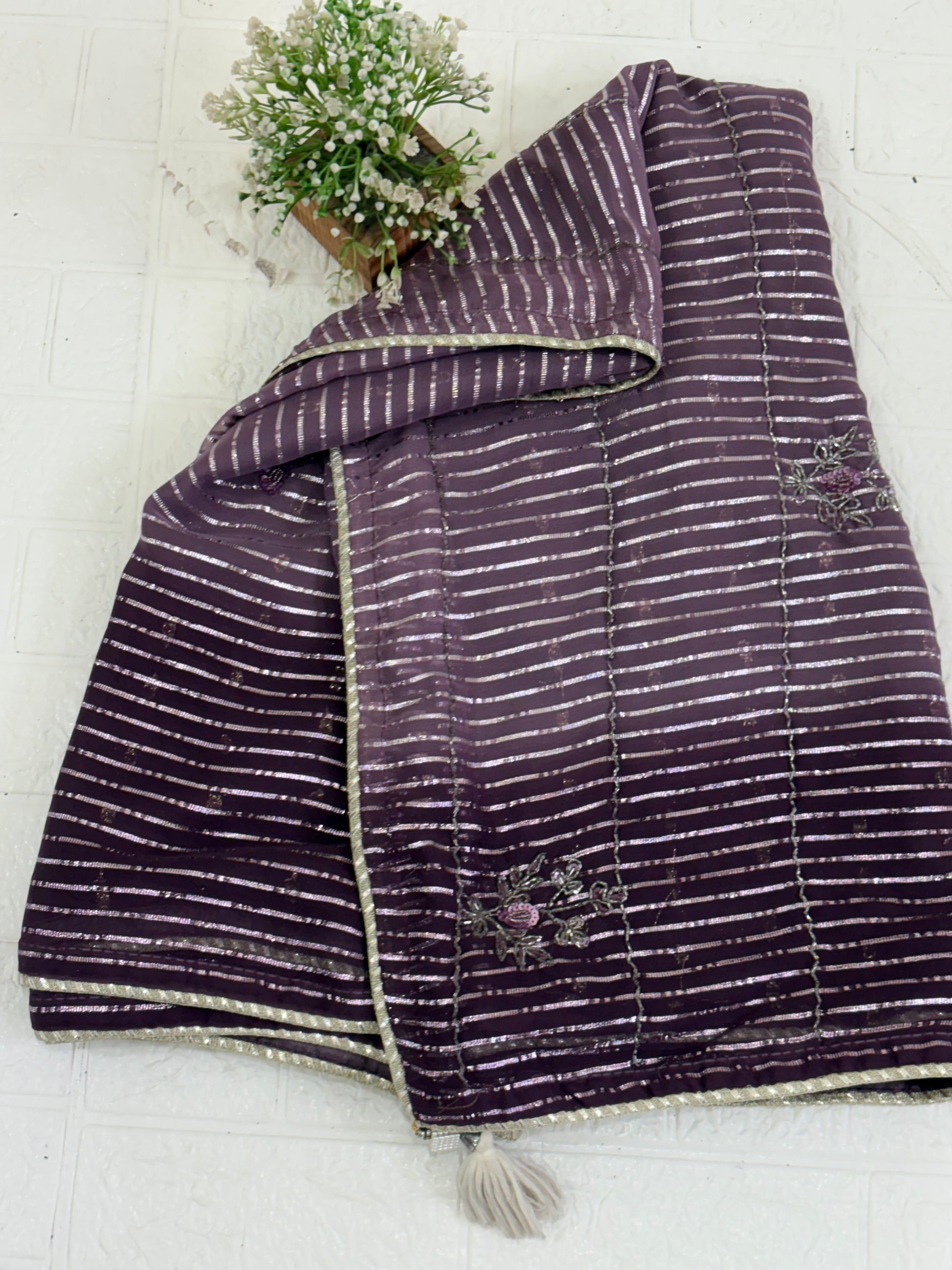 Purple Wine Saree fabric This is a lightweight Organza or Georgette Saree featuring silver Zari (metallic) stripes woven throughout and floral thread/sequin embroidery.