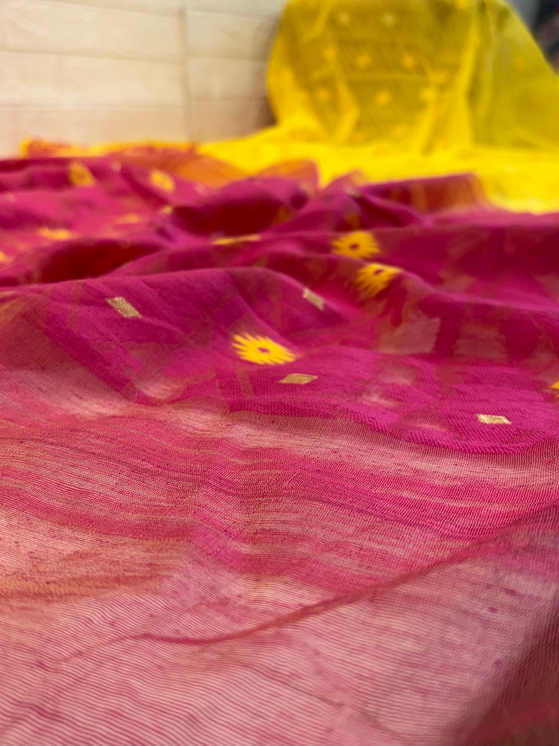 Sunrise Magenta Jamdani Saree cotton Jamdani, featuring a bright yellow body with magenta contrast border and delicate handwoven motifs, light and airy in feel.