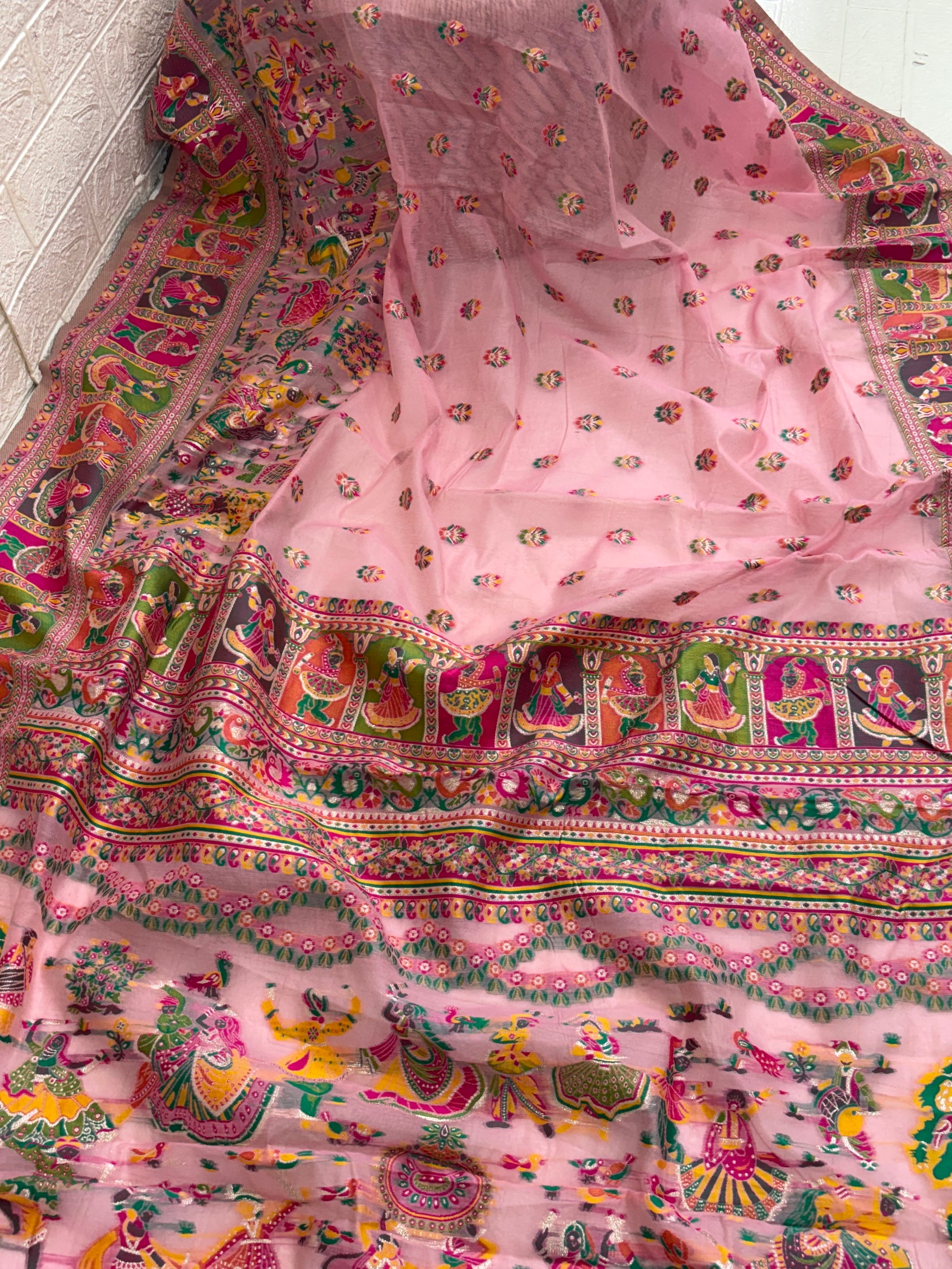 The saree appears to be a Gharchola or a similar style of hand-woven Indian saree, possibly a type of  Chanderi  Silk blend.multicolour in saree and multicolour border best look at festival