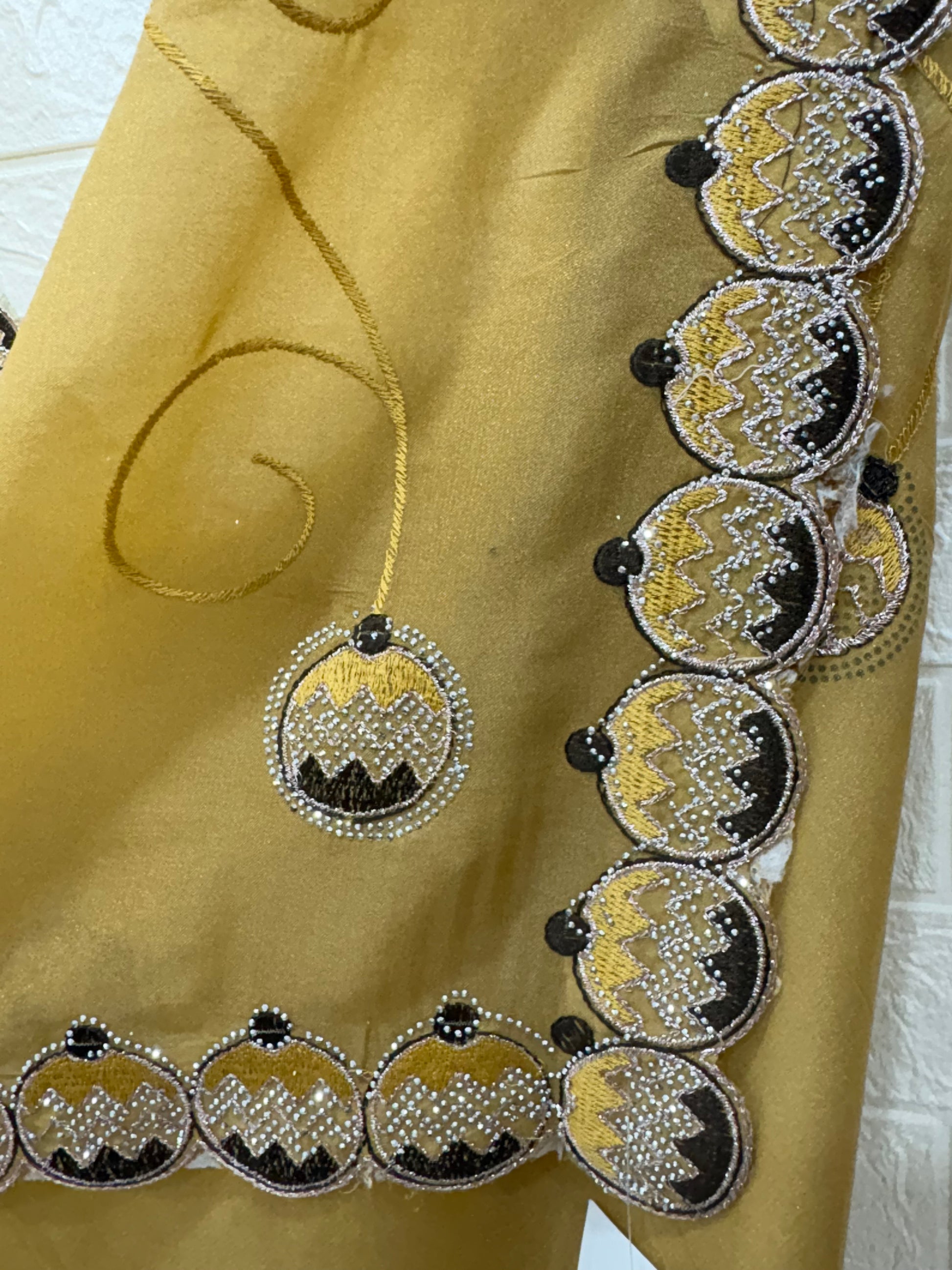 Saree georgette or organza and mustard colour Embroidered Medallion butti and Saree with Scalloped Border it is a sheer saree with scattered embroider and stonework