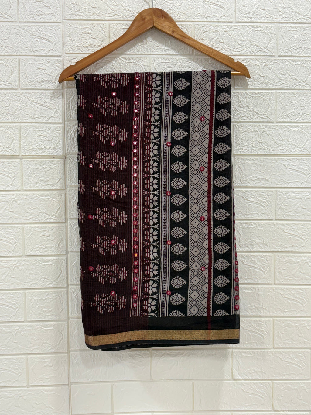 Name: Ebony Block Print Saree
Fabric: Pure cotton with traditional block print motifs, mirror embellishments, and a gold zari border for a classic ethnic charm.