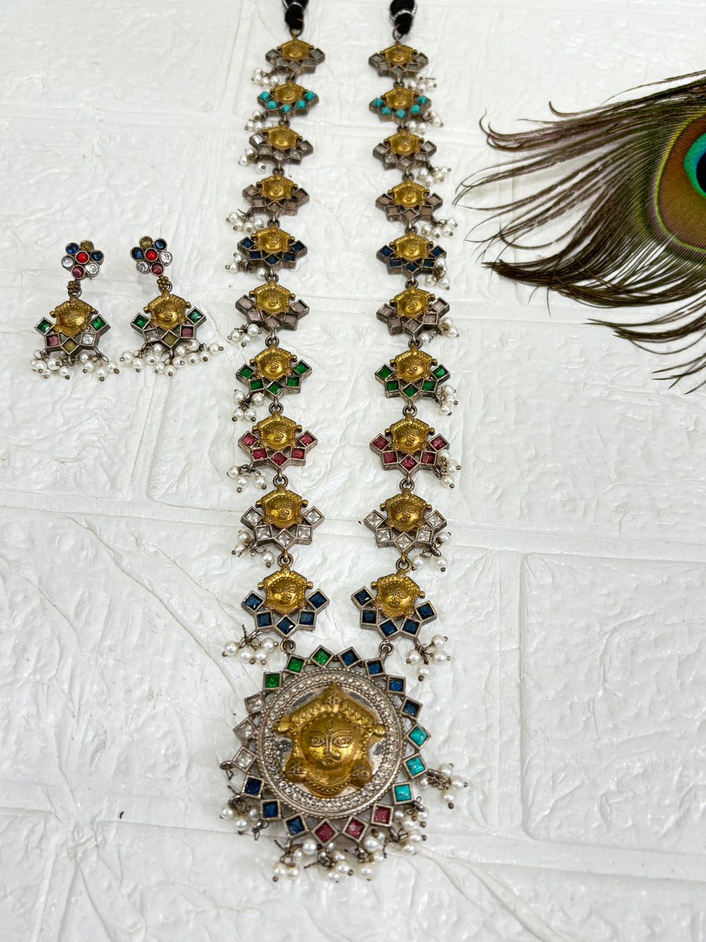 Name: Navrang Devi Haar
Collection: Shaktiya Collection – A divine temple-inspired jewellery line featuring goddess motifs, multicolour stones, and delicate pearl drops, perfect for festive and traditional occasions.