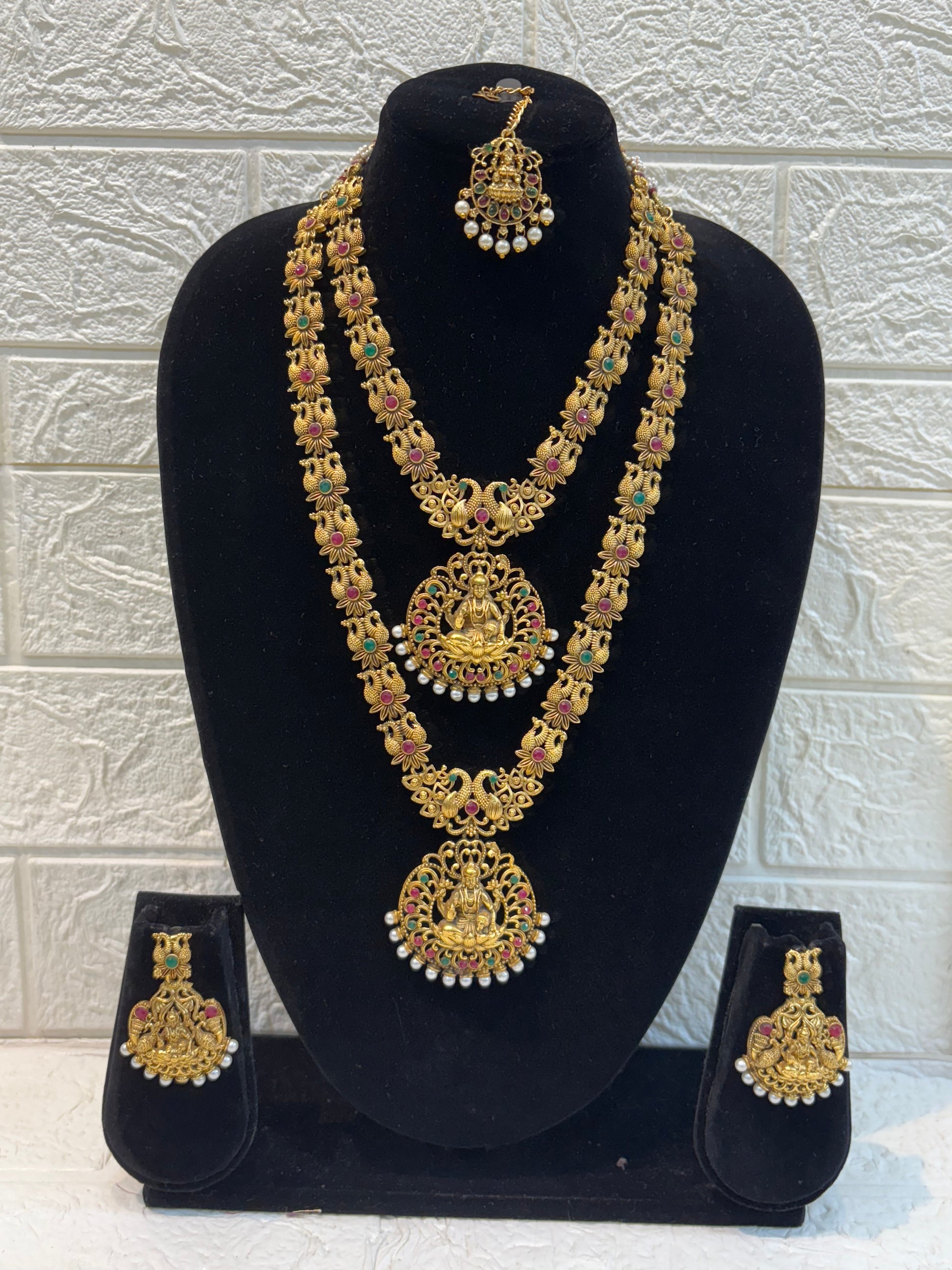 Traditional South Indian temple jewellery featuring Goddess Lakshmi motifs, floral links, and pearl drops—perfect for weddings, festive occasions, and classical saree looks.