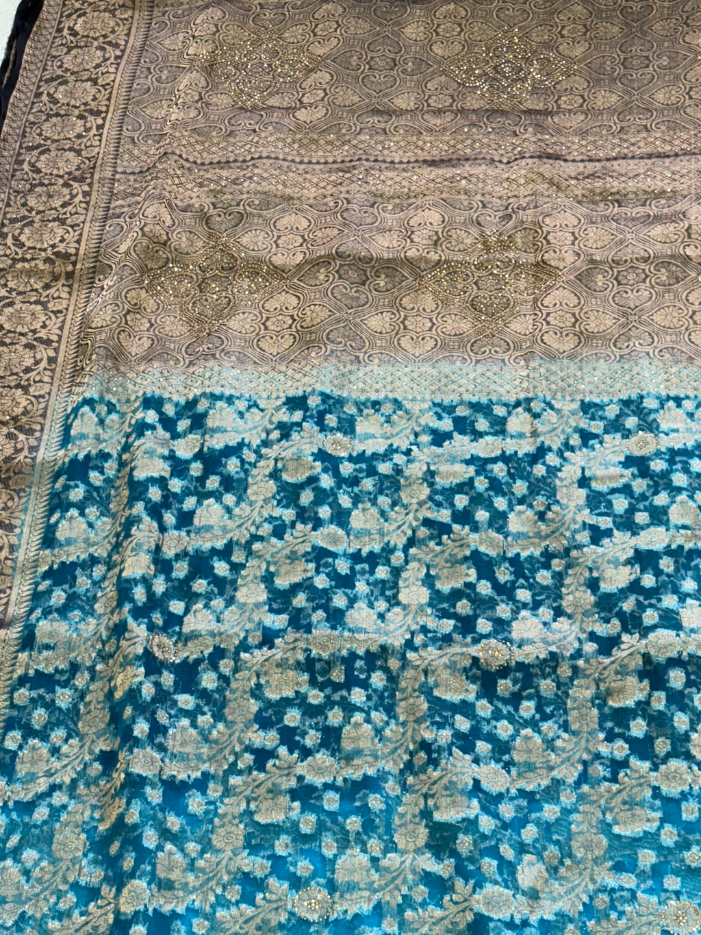 Fabric This is a Banarasi organza Saree with colour is blue heavy gold Zari Brocade (or Katan Silk) weave and subtle sequin/stone embellishments.