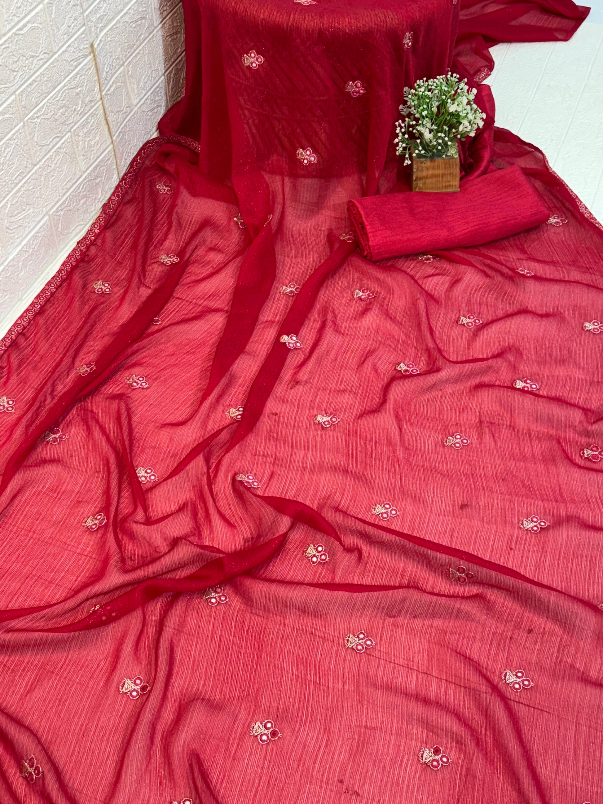 Crimson Pearl Butti Saree
Made from soft georgette fabric, this elegant red saree is adorned with delicate pearl butti work, giving a light, graceful drape perfect for festive and party wear.