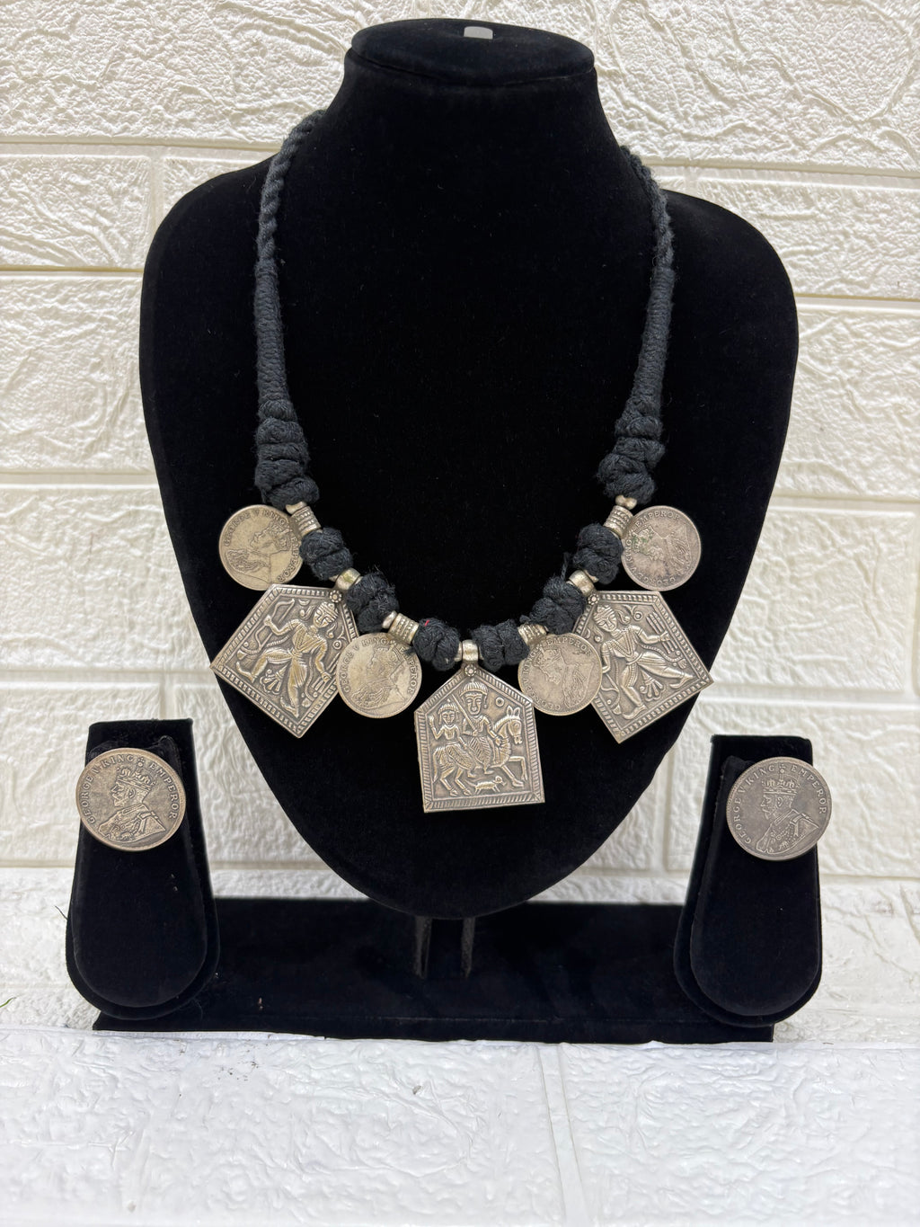 Name:
Tribal Coin Pendant Necklace Set Handcrafted oxidised silver necklace with vintage coin charms and matching earrings, perfect for adding a bold ethnic touch to festive outfits.