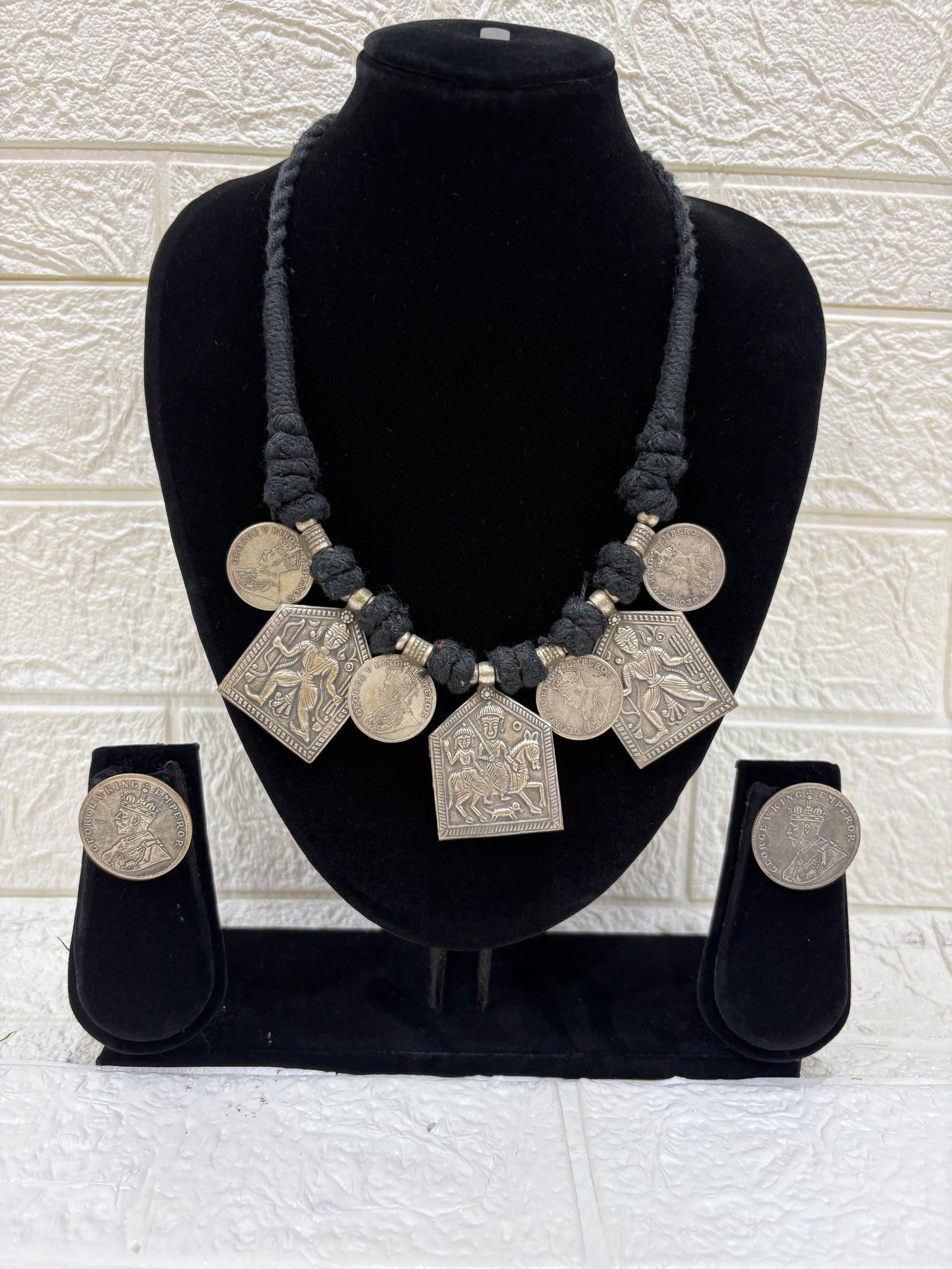 Name:
Tribal Coin Pendant Necklace Set Handcrafted oxidised silver necklace with vintage coin charms and matching earrings, perfect for adding a bold ethnic touch to festive outfits.