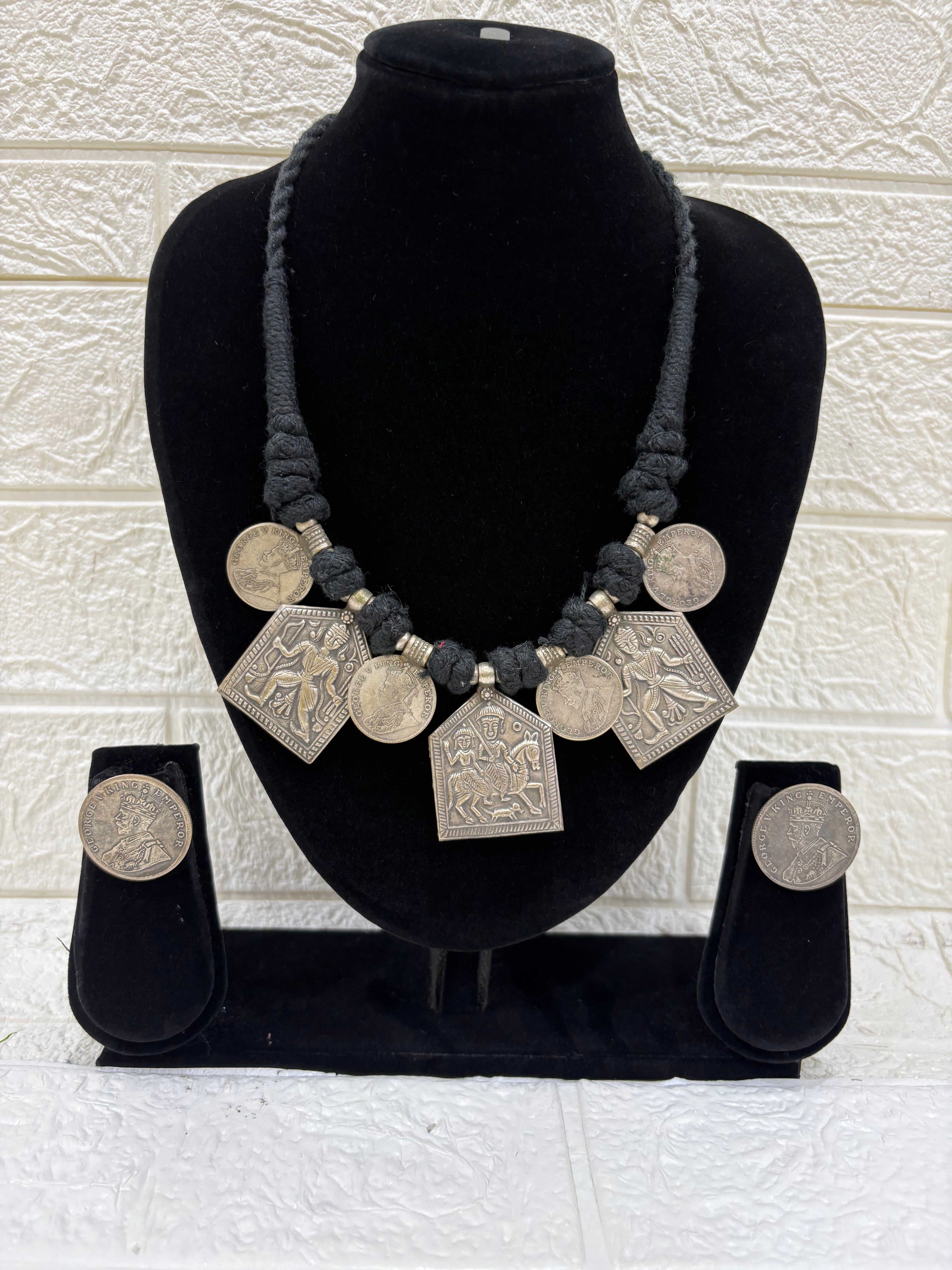Name:
Tribal Coin Pendant Necklace Set Handcrafted oxidised silver necklace with vintage coin charms and matching earrings, perfect for adding a bold ethnic touch to festive outfits.