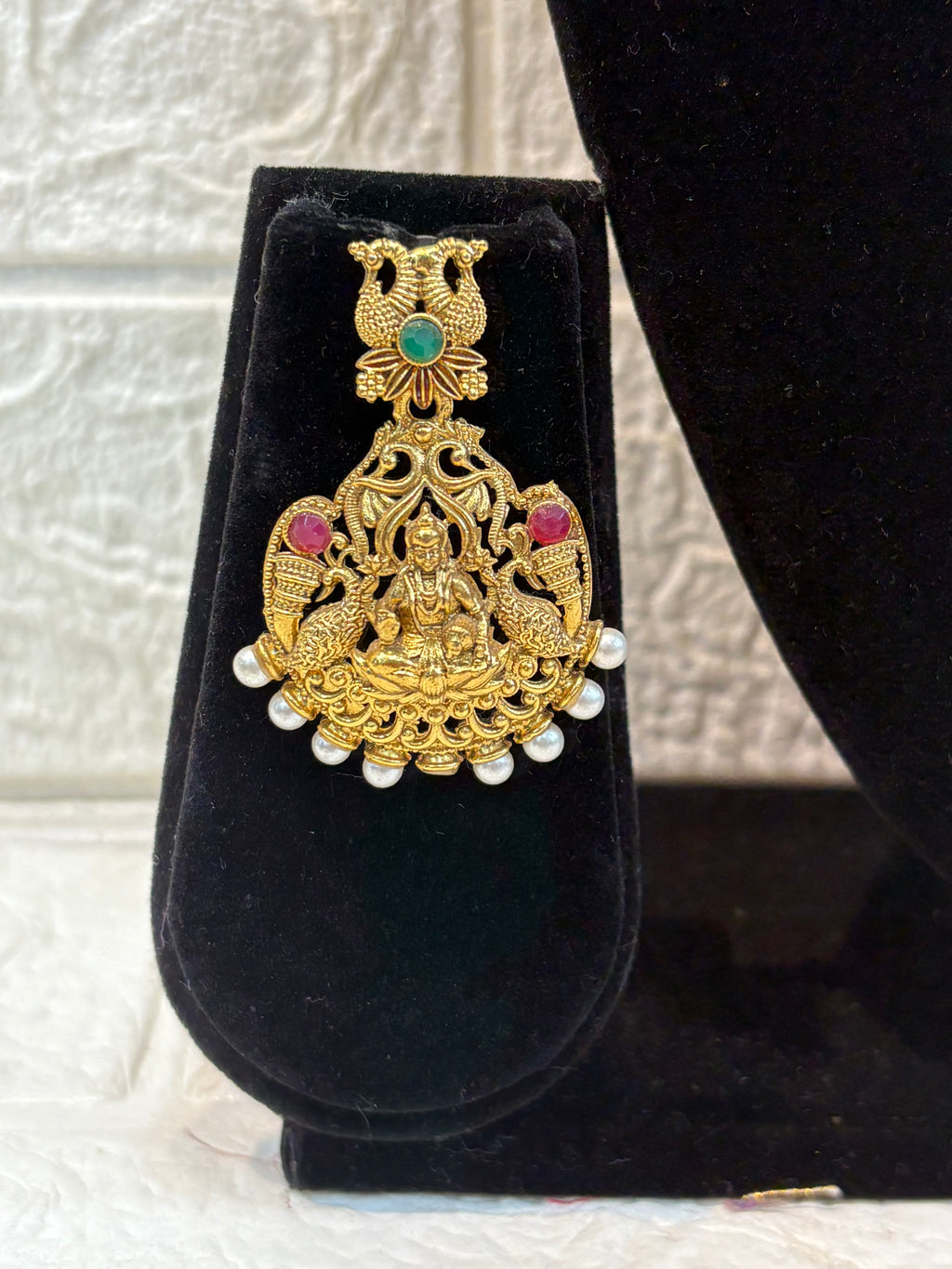 Traditional South Indian temple jewellery featuring Goddess Lakshmi motifs, floral links, and pearl drops—perfect for weddings, festive occasions, and classical saree looks.