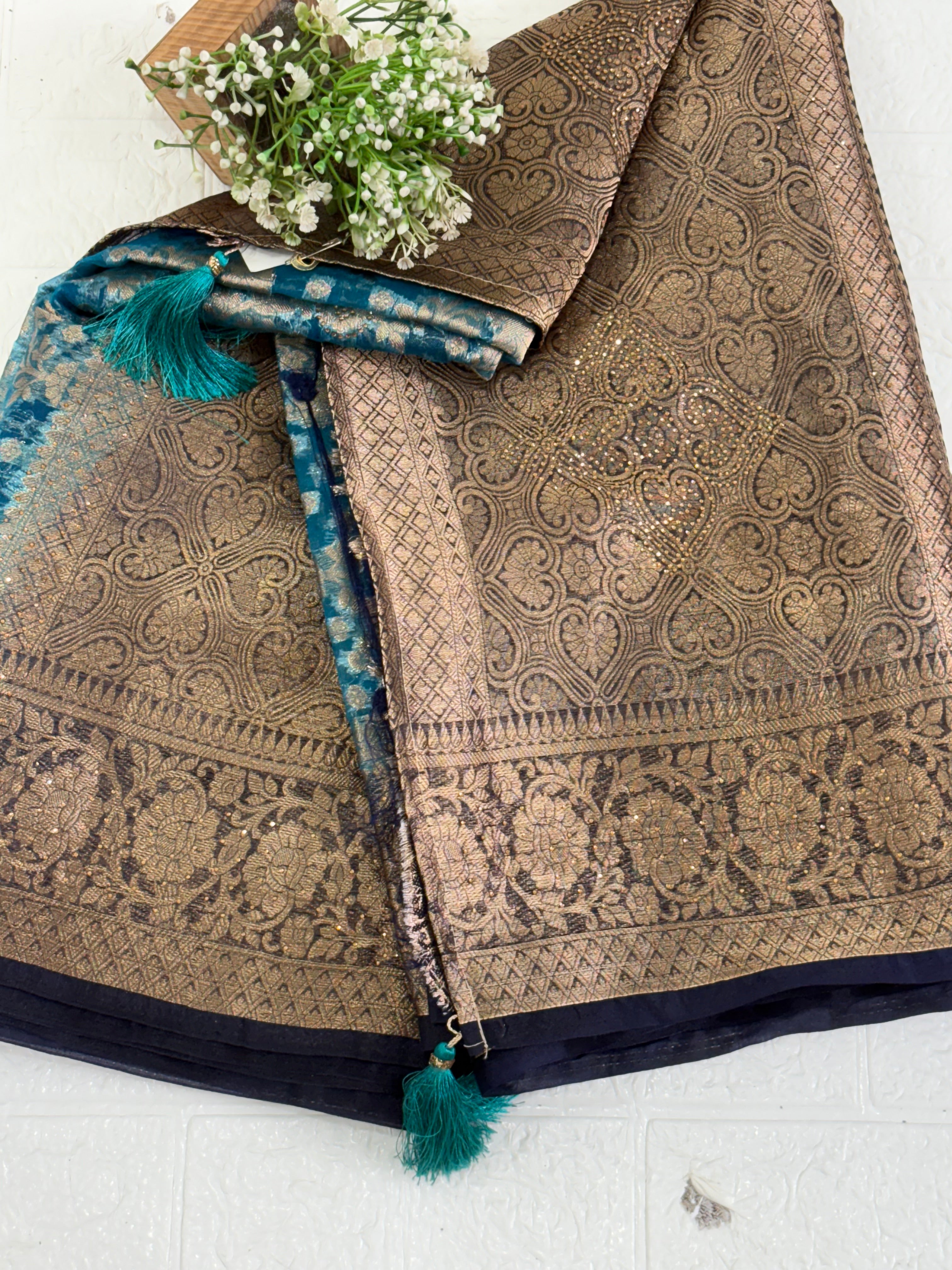 Fabric This is a Banarasi organza Saree with colour is blue heavy gold Zari Brocade (or Katan Silk) weave and subtle sequin/stone embellishments.