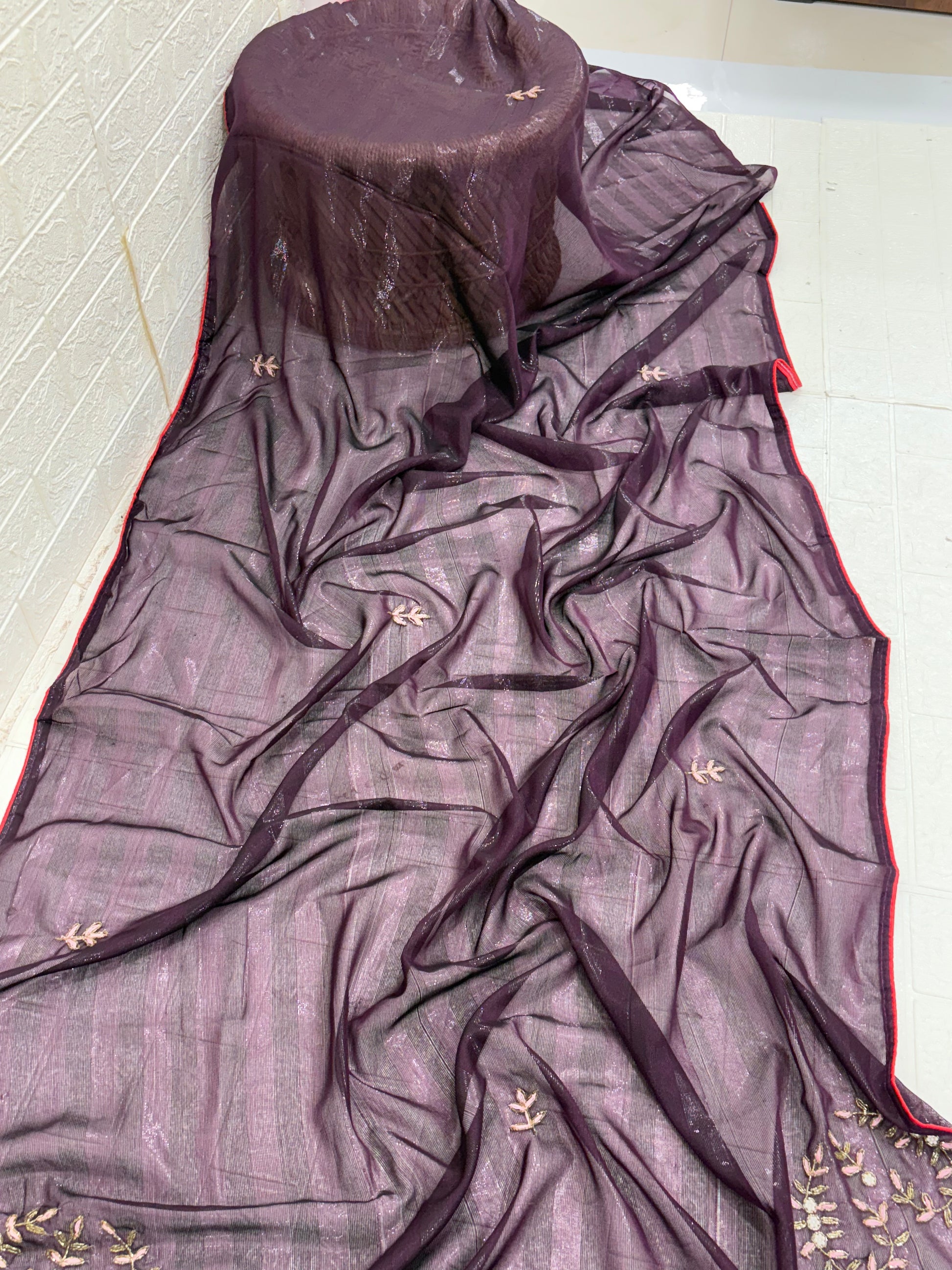 The saree is a Dark Purple Striped Saree with lightweight organza or georgette saree Floral Embroidery.and blouse light pink colour