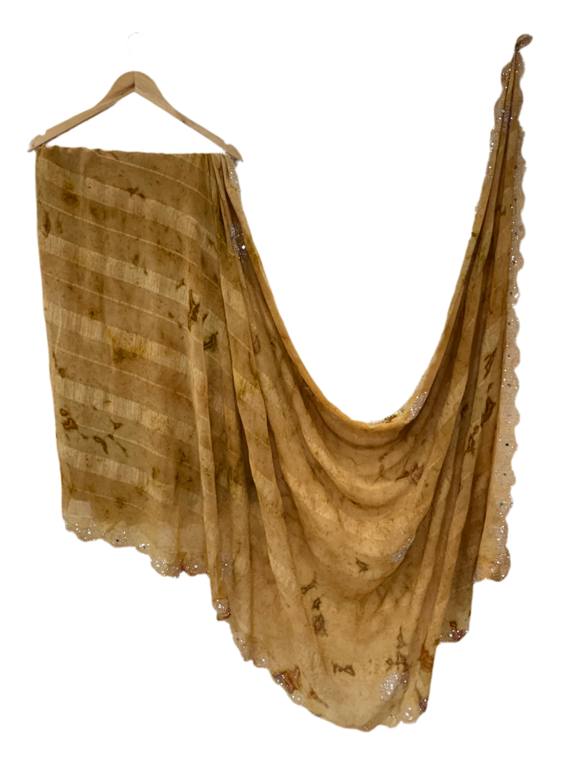 Saree with woven mirror work or light mustard and light brown colour small motif the pattern is a motif woven the sheer georgette fabric silk with mirror work in saree this fabric is known for it’s sheer lightweight texture