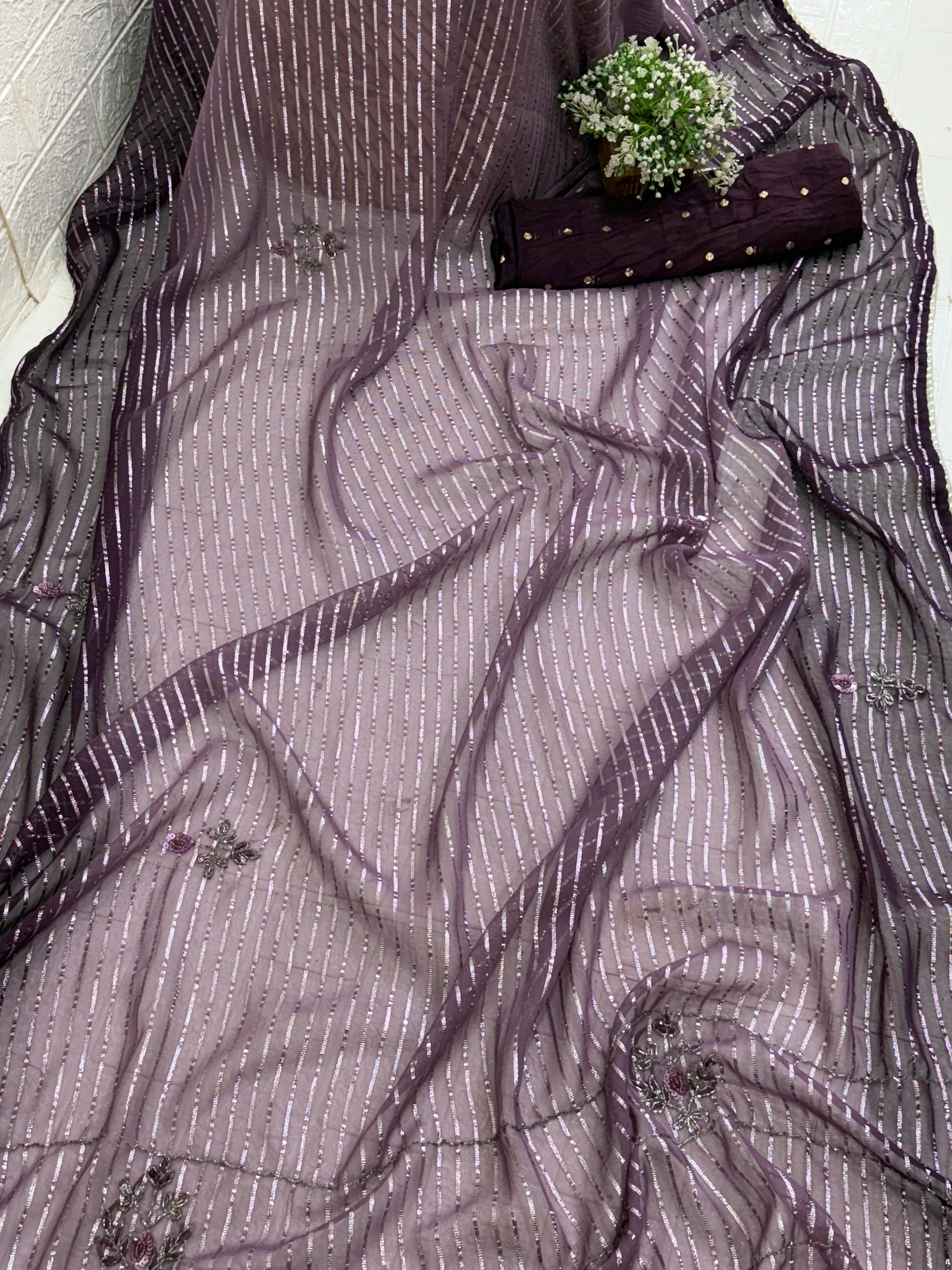 Purple Wine Saree fabric This is a lightweight Organza or Georgette Saree featuring silver Zari (metallic) stripes woven throughout and floral thread/sequin embroidery.