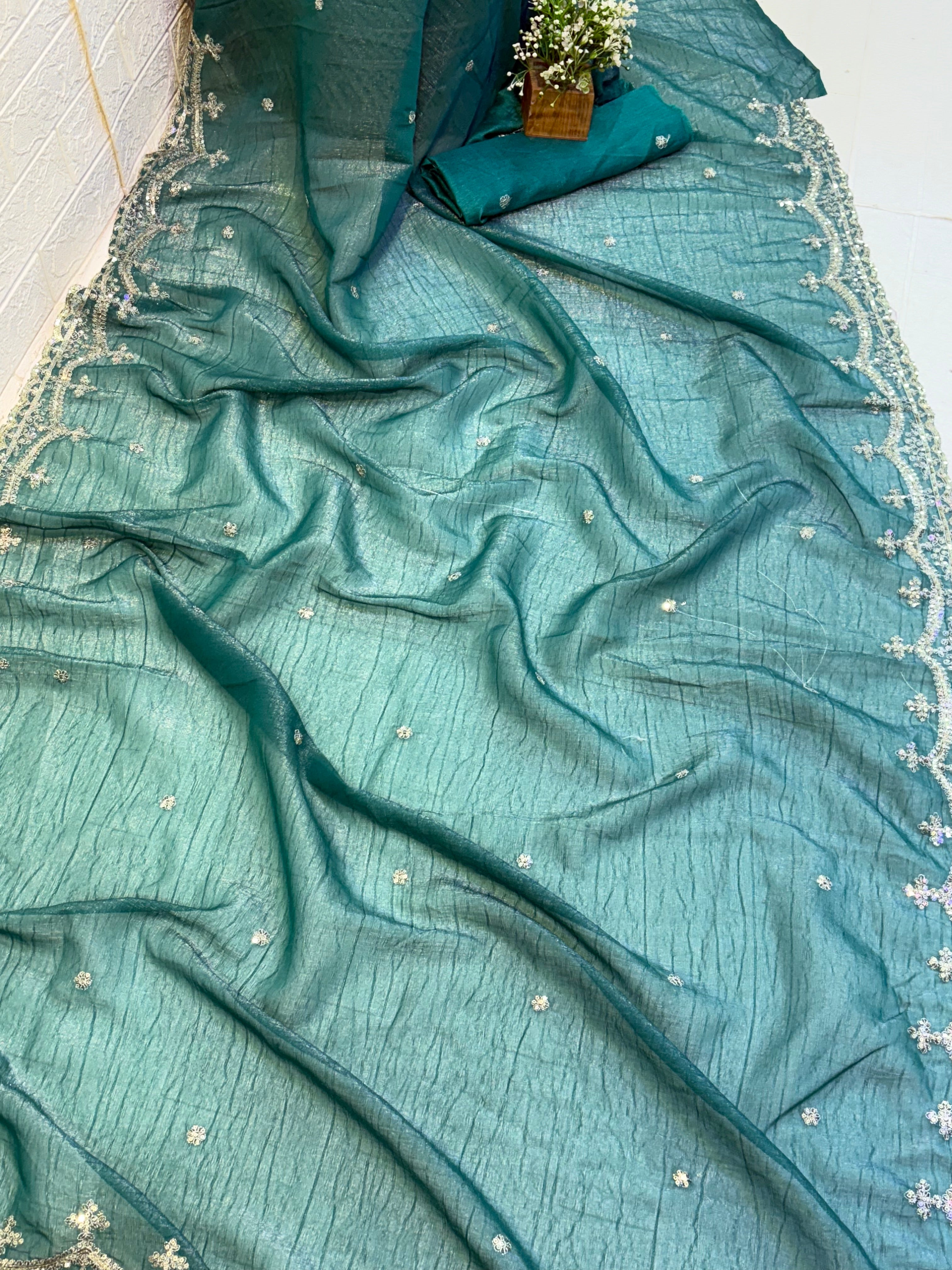 Name: Teal Green burberry silk Saree Elegant with delicate pearl and sequin floral embroidery along the border and scattered motifs across the drape.