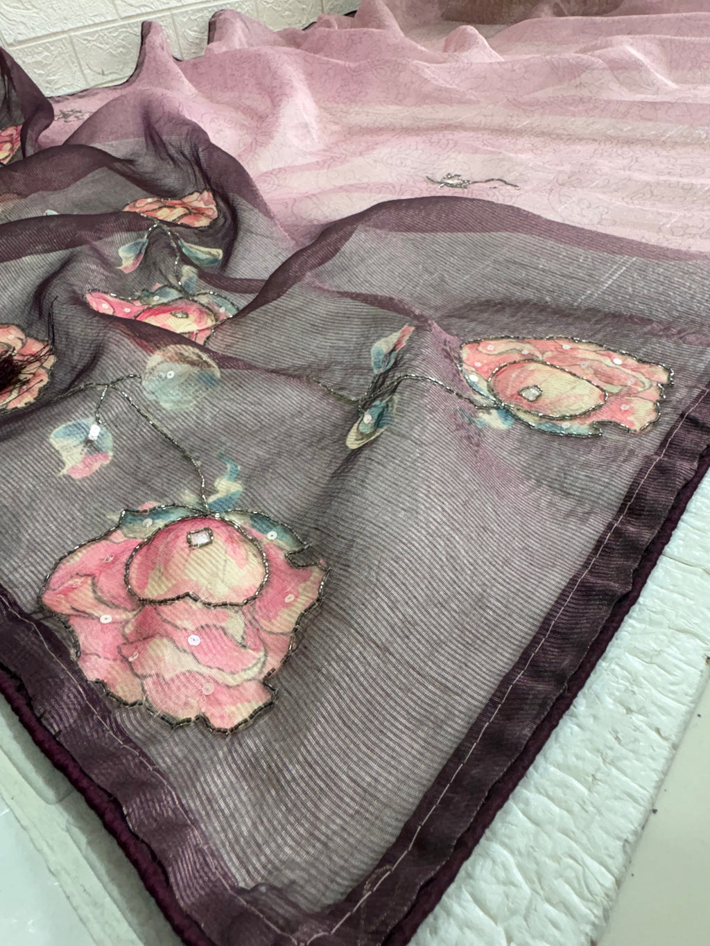 Name: Lavender Floral rust tissue fabric Saree
Lightweight with subtle floral embroidery and pastel printed motifs, offering a soft and elegant sheen.