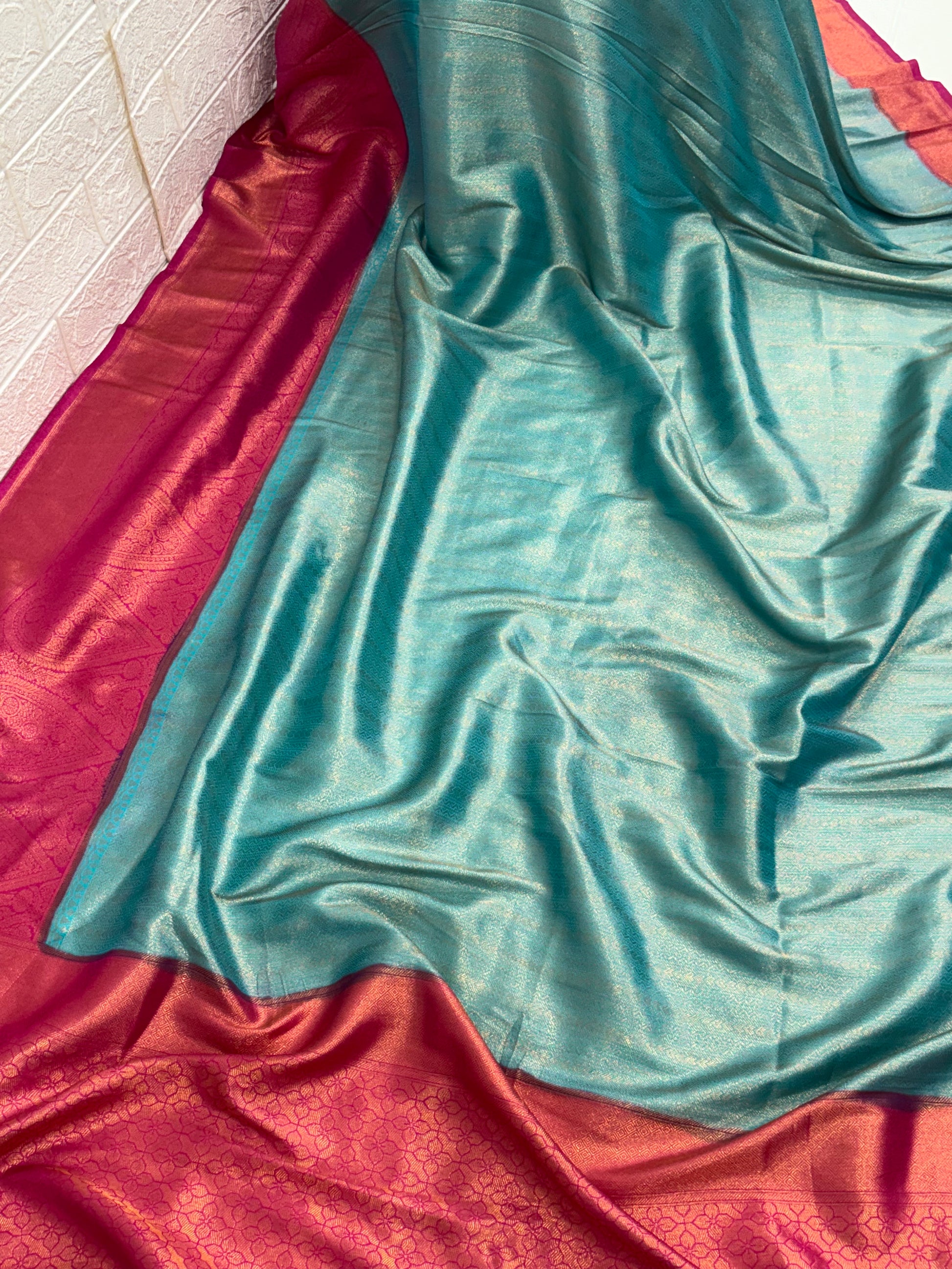 Kanchipuram Silk  (Silk Blend) A traditional dual-panel fabric, featuring a shot-effect reddish-pink and  golden top with woven motifs and a light blue aqua-colored bottom with woven self-stripes.