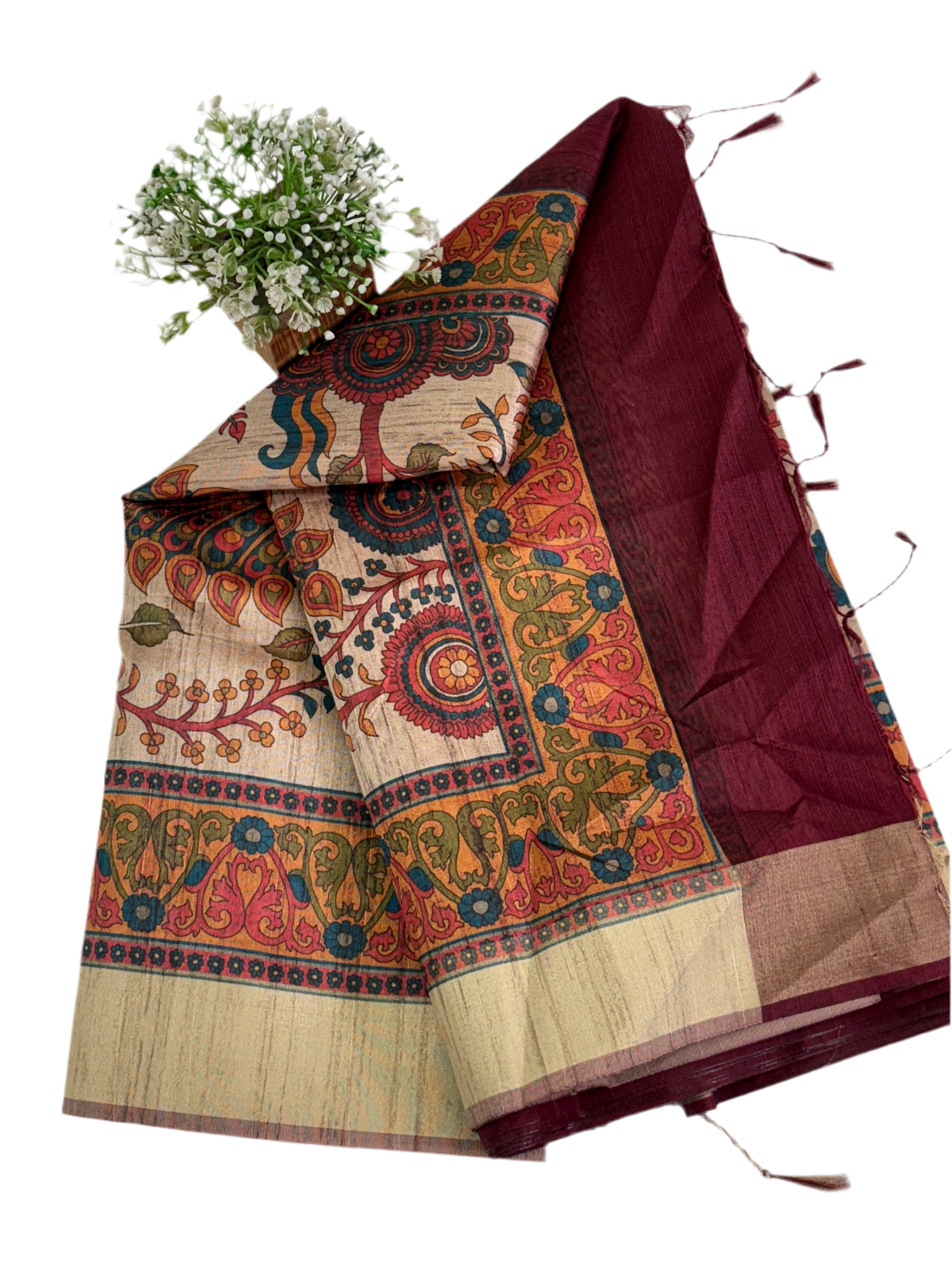 Fabric: Likely Art Silk, The body has a slub/raw silk texture (Maroon/Burgundy), and the pallu features a detailed, nature-inspired design with peacock motifs, which is characteristic of Kalamkari art.
