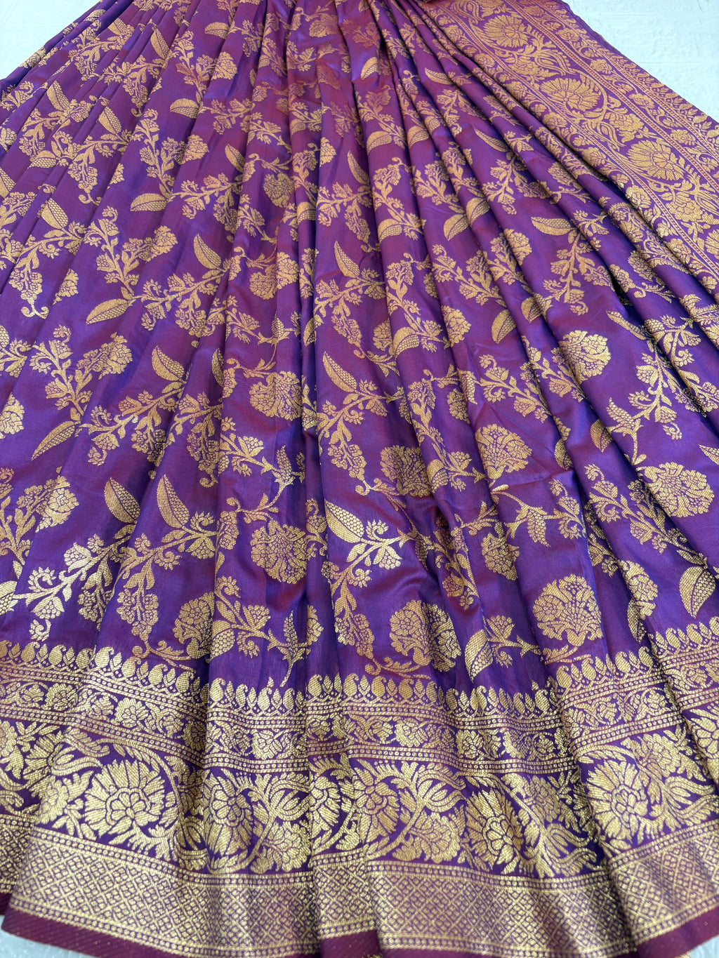 Name: Patola-Style or Kanchipuram Checked Silk Saree purple colour with golden work featuring a woven geometric check and floral zari work.