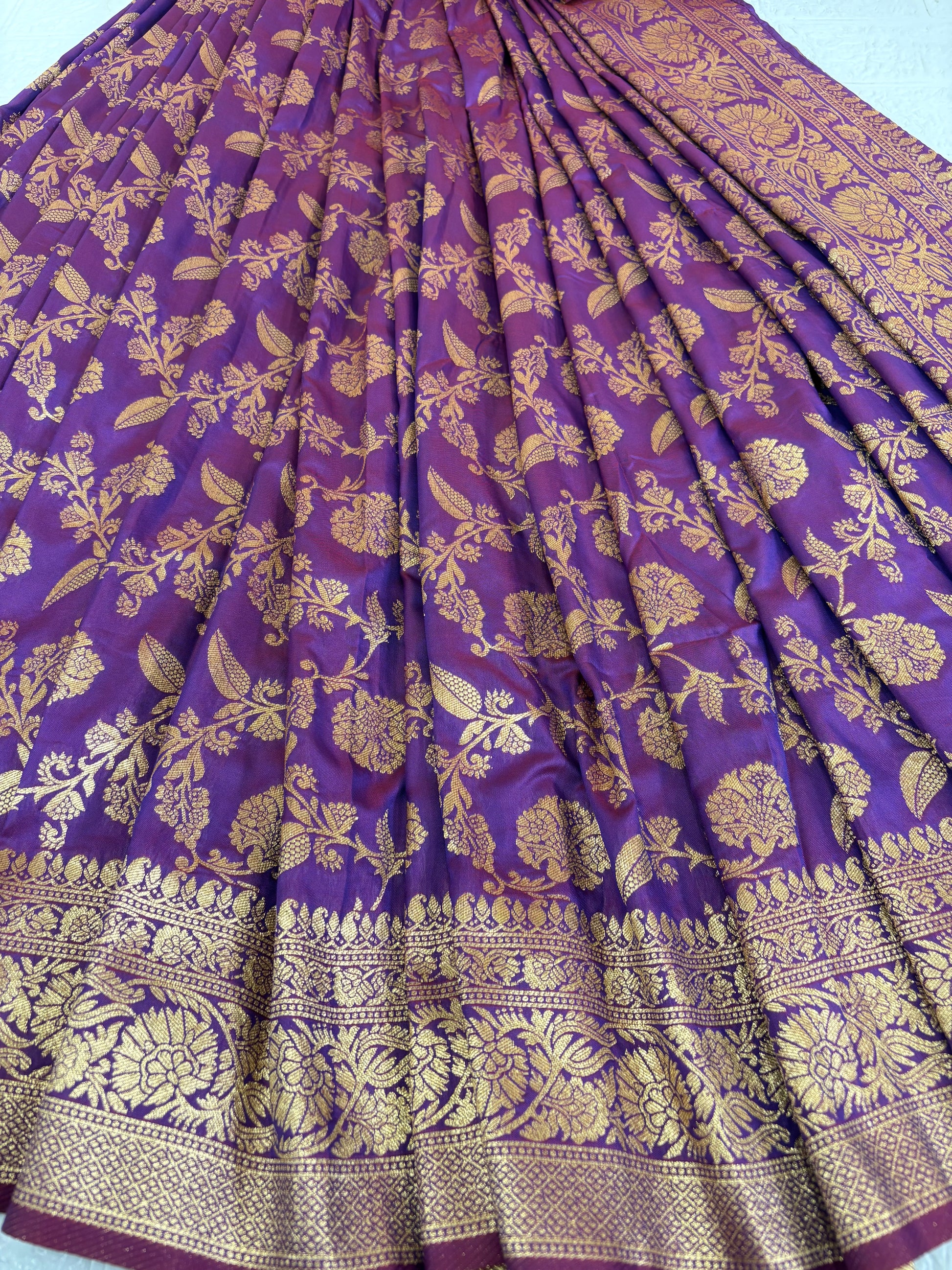 Name: Patola-Style or Kanchipuram Checked Silk Saree purple colour with golden work featuring a woven geometric check and floral zari work.