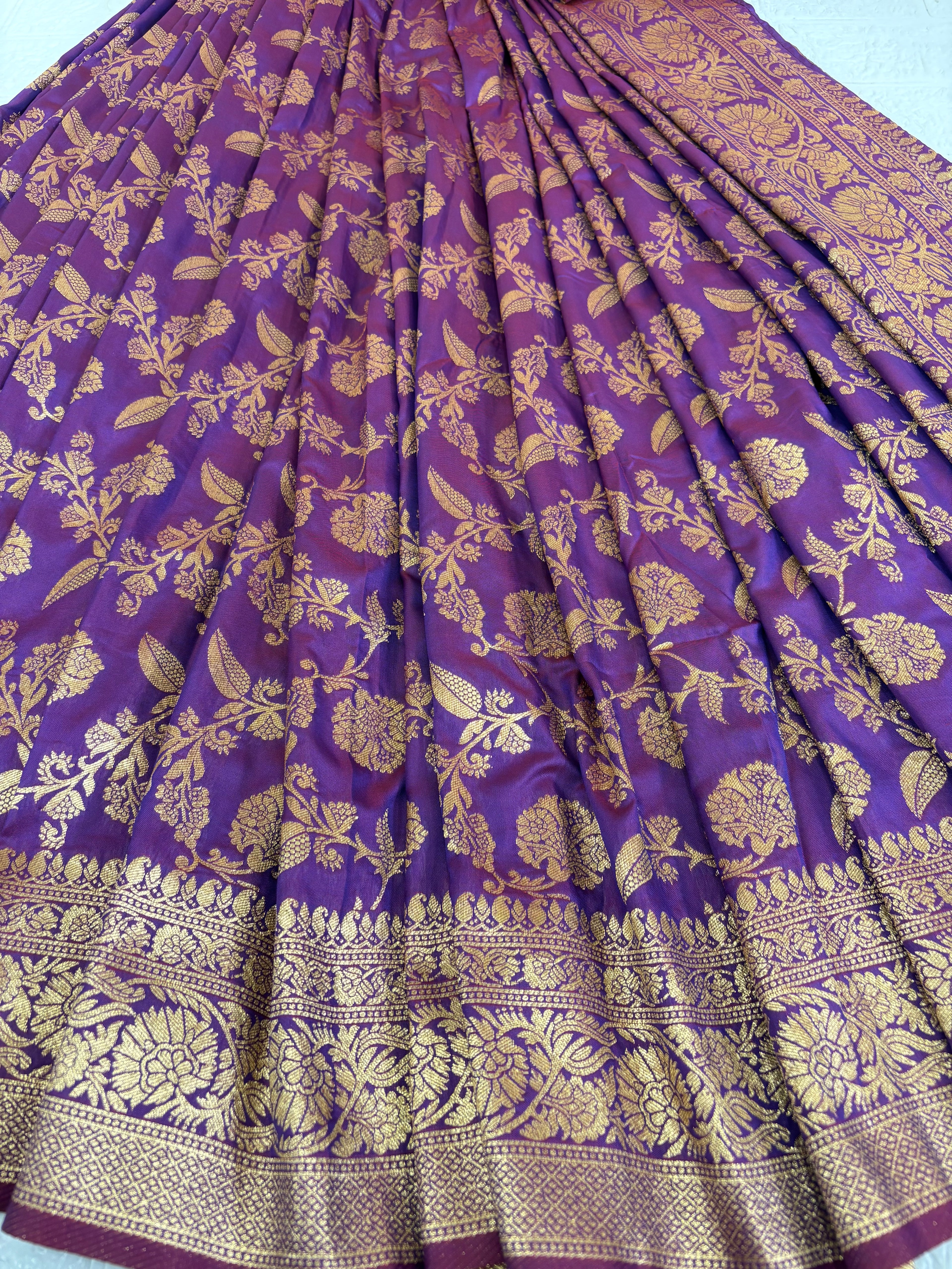 Name: Patola-Style or Kanchipuram Checked Silk Saree purple colour with golden work featuring a woven geometric check and floral zari work.