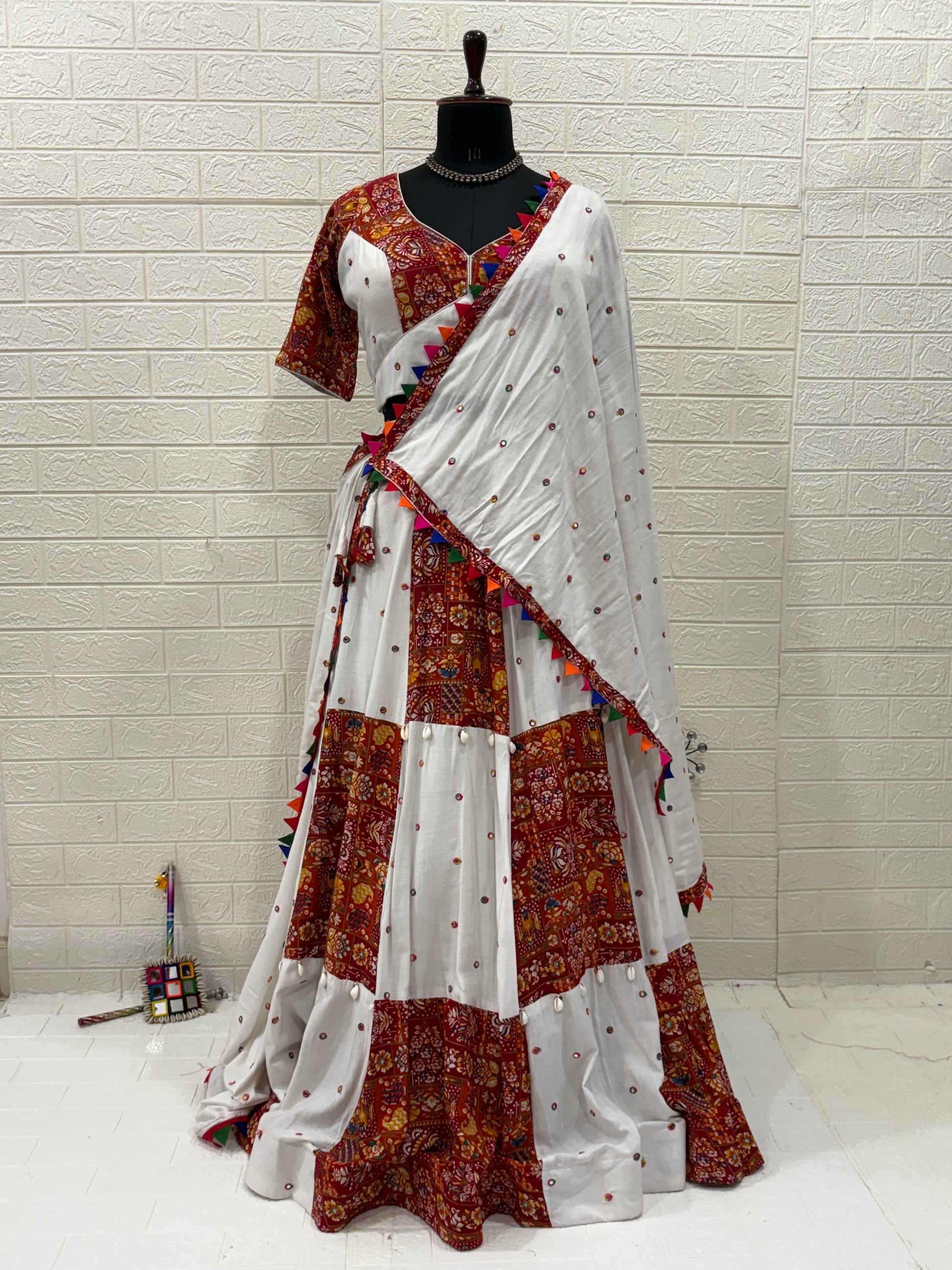 Name:
Rust & Ivory Ajrakh Lehenga Handcrafted soft cotton  lehenga with cowrie shell in rust ajrakh and ivory panels, paired with a matching White dupatta with playful perfect for a vibrant Navratri look.