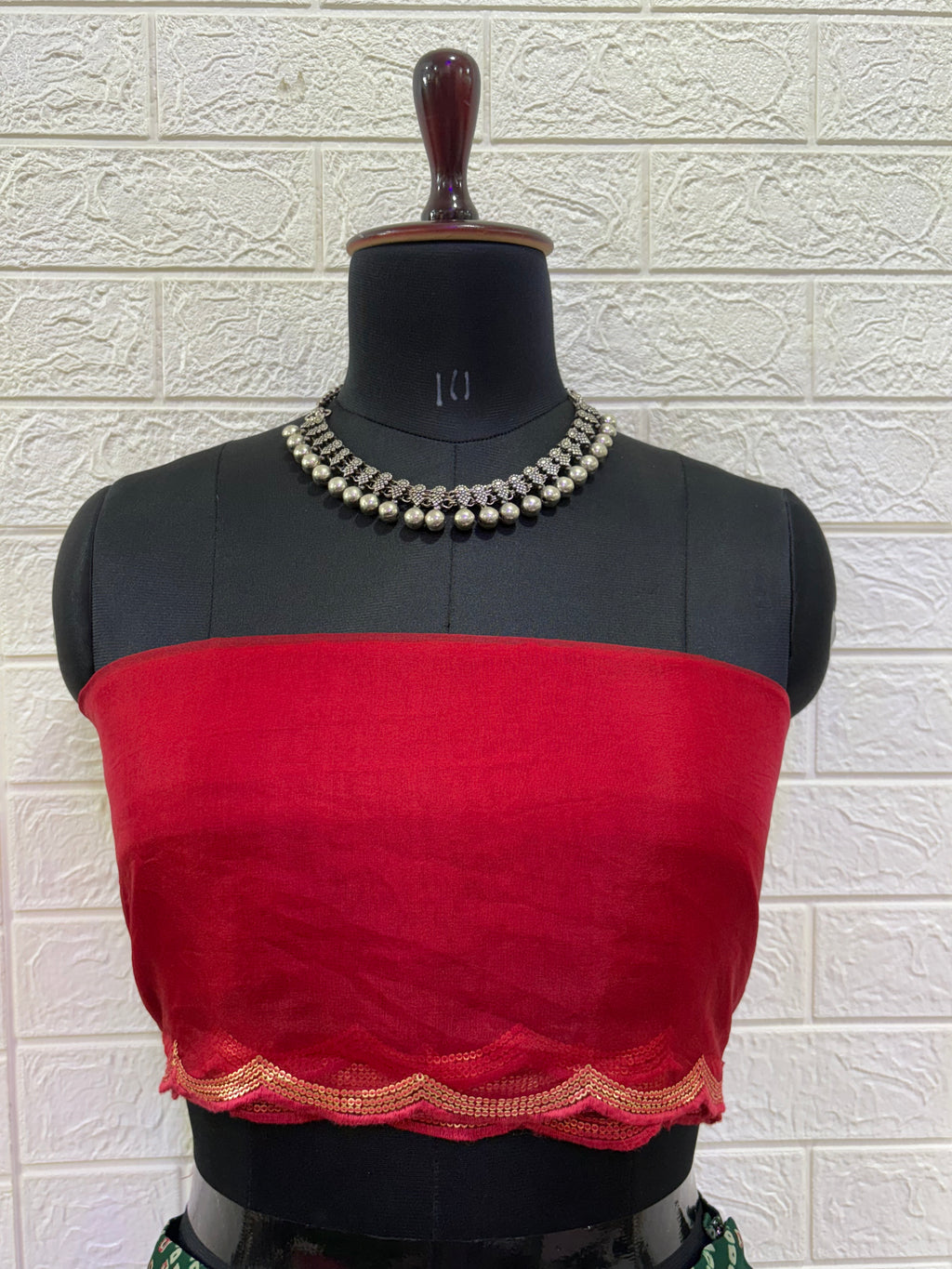 Name:
Emerald Bandhani Lehenga Set Crafted in pure Georgette bandhani print with a deep green flared lehenga and contrast red blouse, finished with golden lace border for a classic festive look.