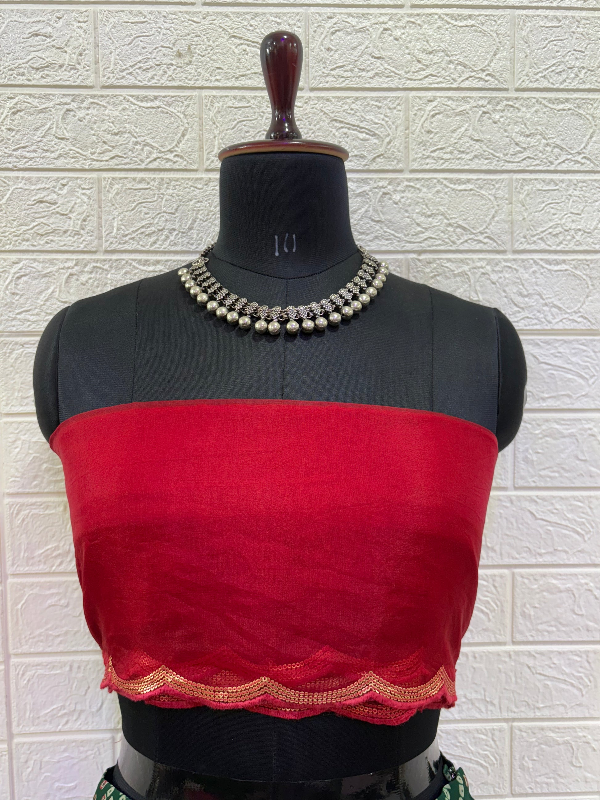 Name:
Emerald Bandhani Lehenga Set Crafted in pure Georgette bandhani print with a deep green flared lehenga and contrast red blouse, finished with golden lace border for a classic festive look.