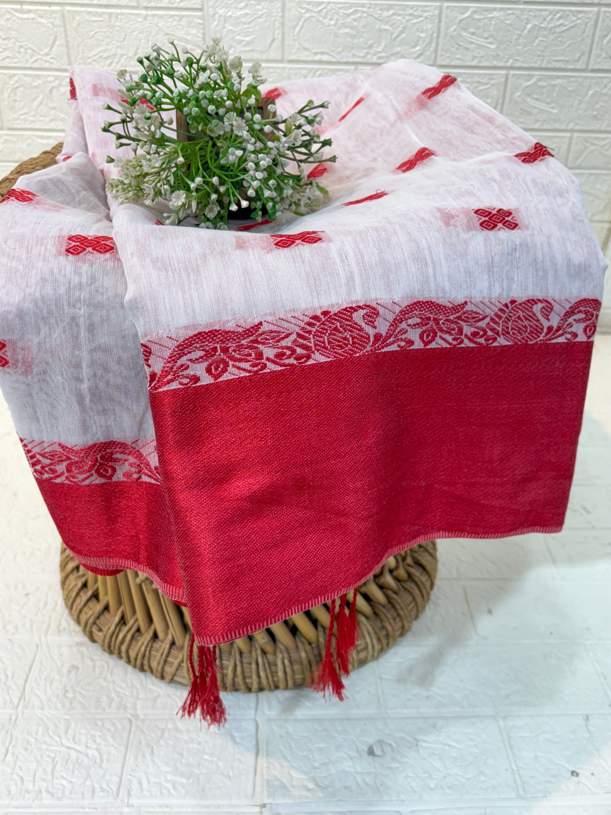 Cotton Jamdani Saree
Made from soft cotton Jamdani, featuring an elegant off-white body with red woven butis and a rich maroon-red border for a classic, graceful look.