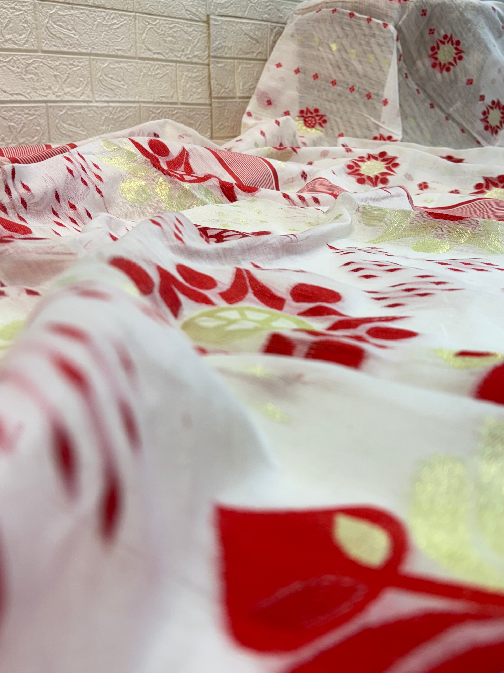 Classic Red Bloom Jamdani Saree cotton Jamdani, showcasing traditional red floral motifs with subtle gold accents on a soft, sheer handwoven base.