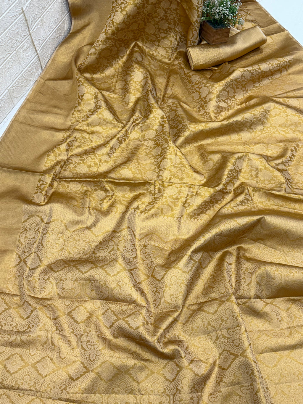 Patola or Kanjivaram Silk Saree / Brocade. And golden colour with Matching blouse This is a silk fabric with all-over woven checkered patterns and floral motifs, often called a checked Kanjivaram or Patola design.