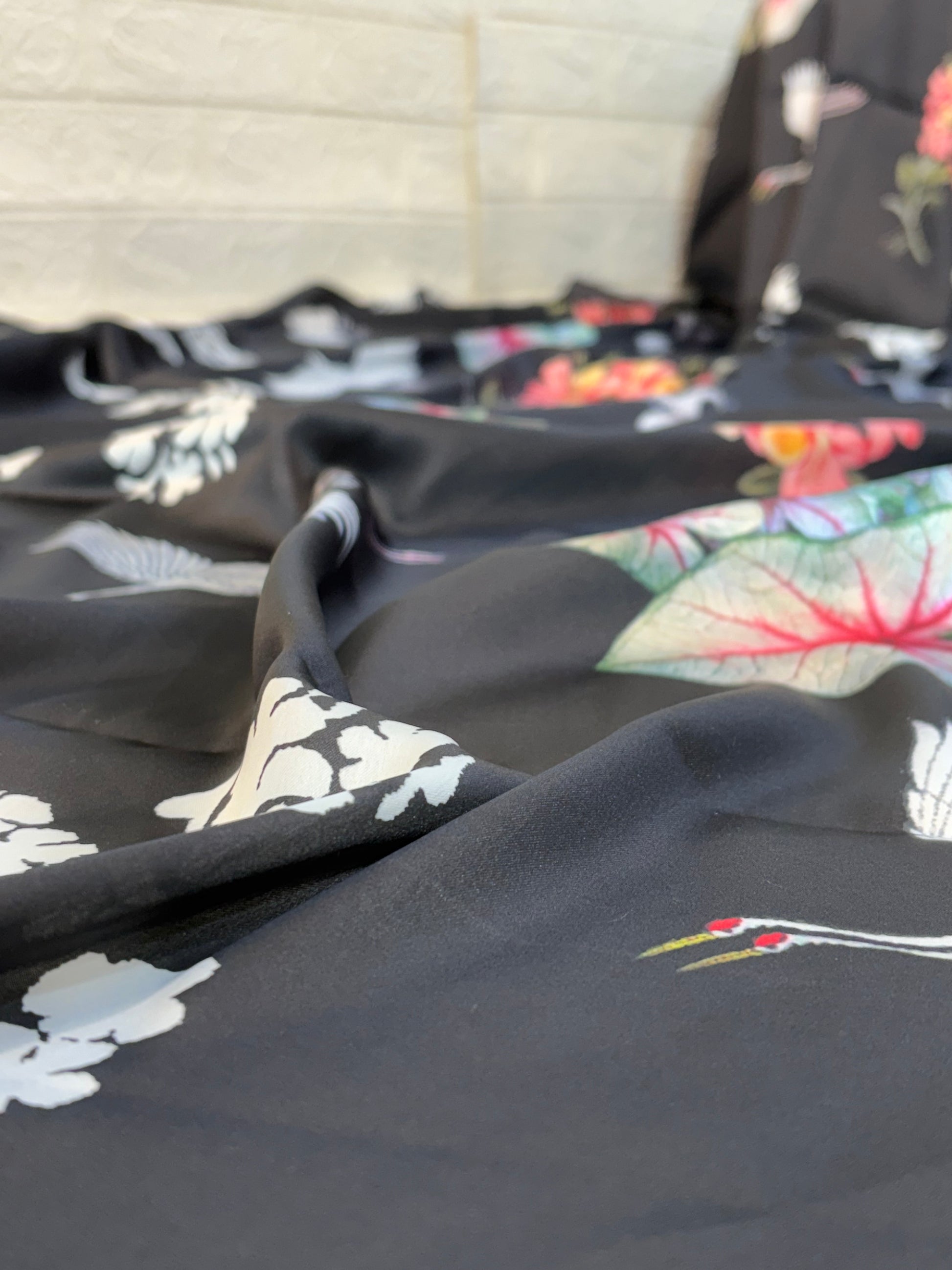 Midnight Crane Floral Saree
Made from soft satin fabric, this black saree is adorned with elegant crane bird and floral prints, offering a smooth drape with a modern, graceful appeal.