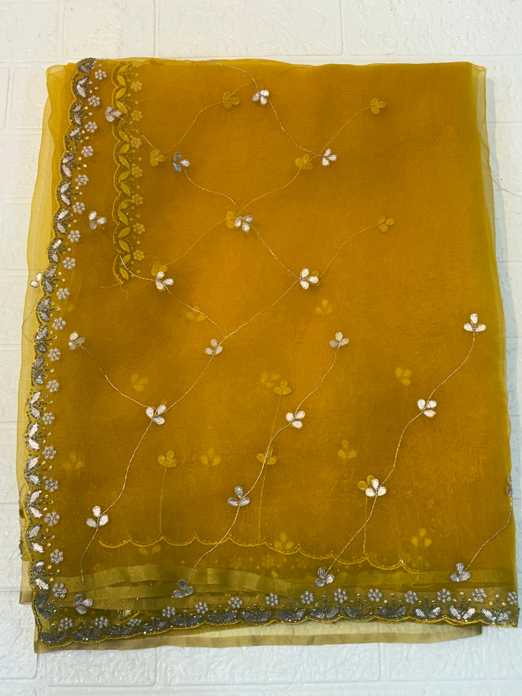 Fabric Soft pure organza adorned with mustard yellow colour delicate floral sequin embroidery and scalloped zari border and Maching blouse with embroidery