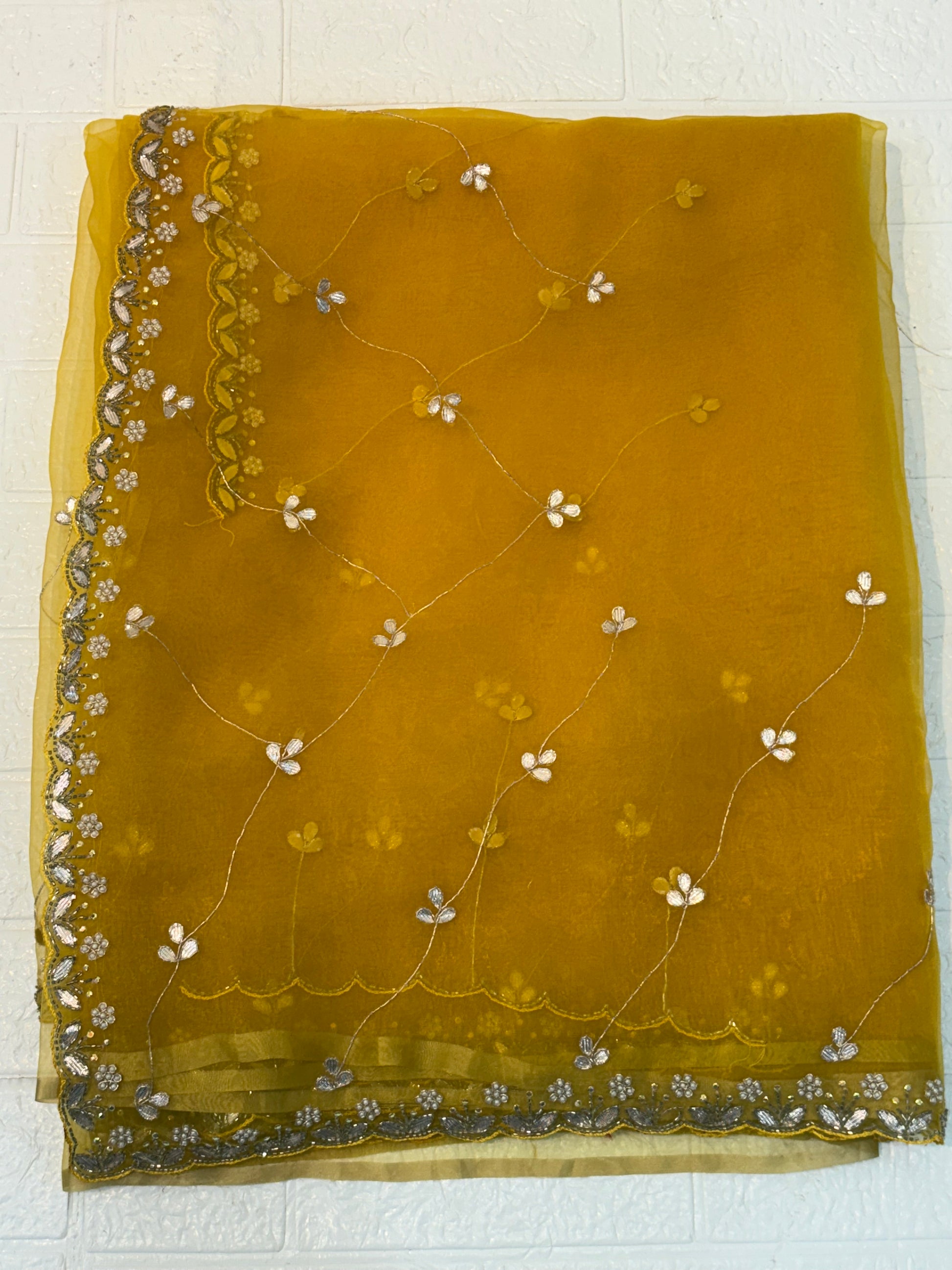 Fabric Soft pure organza adorned with mustard yellow colour delicate floral sequin embroidery and scalloped zari border and Maching blouse with embroidery