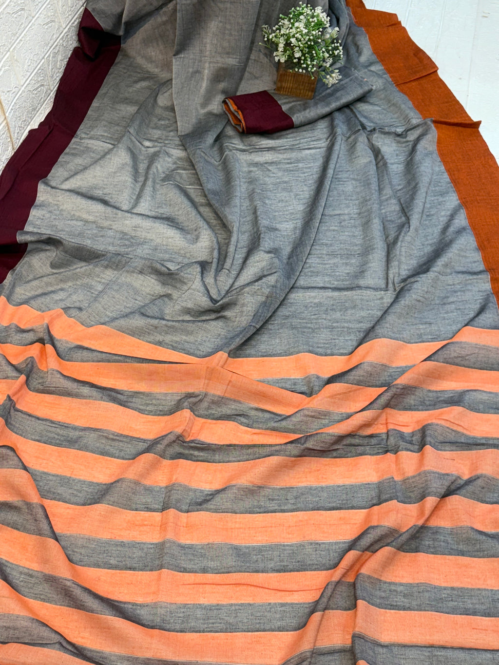 Name: Handwoven Linen Saree cotton Pure linen with dual-tone grey base and peach-grey striped pallu, featuring maroon and rust borders.