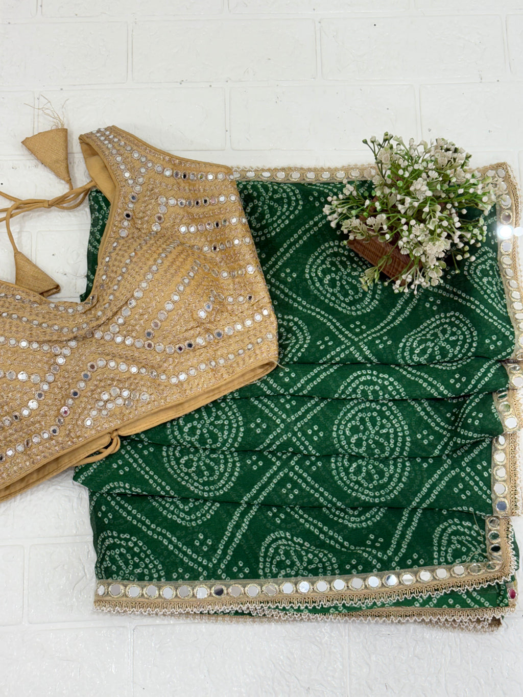 Bandhani Print Fabric crepe Silk Blend with traditional tie-dye pattern and mirror-work golden blouse embellishment.