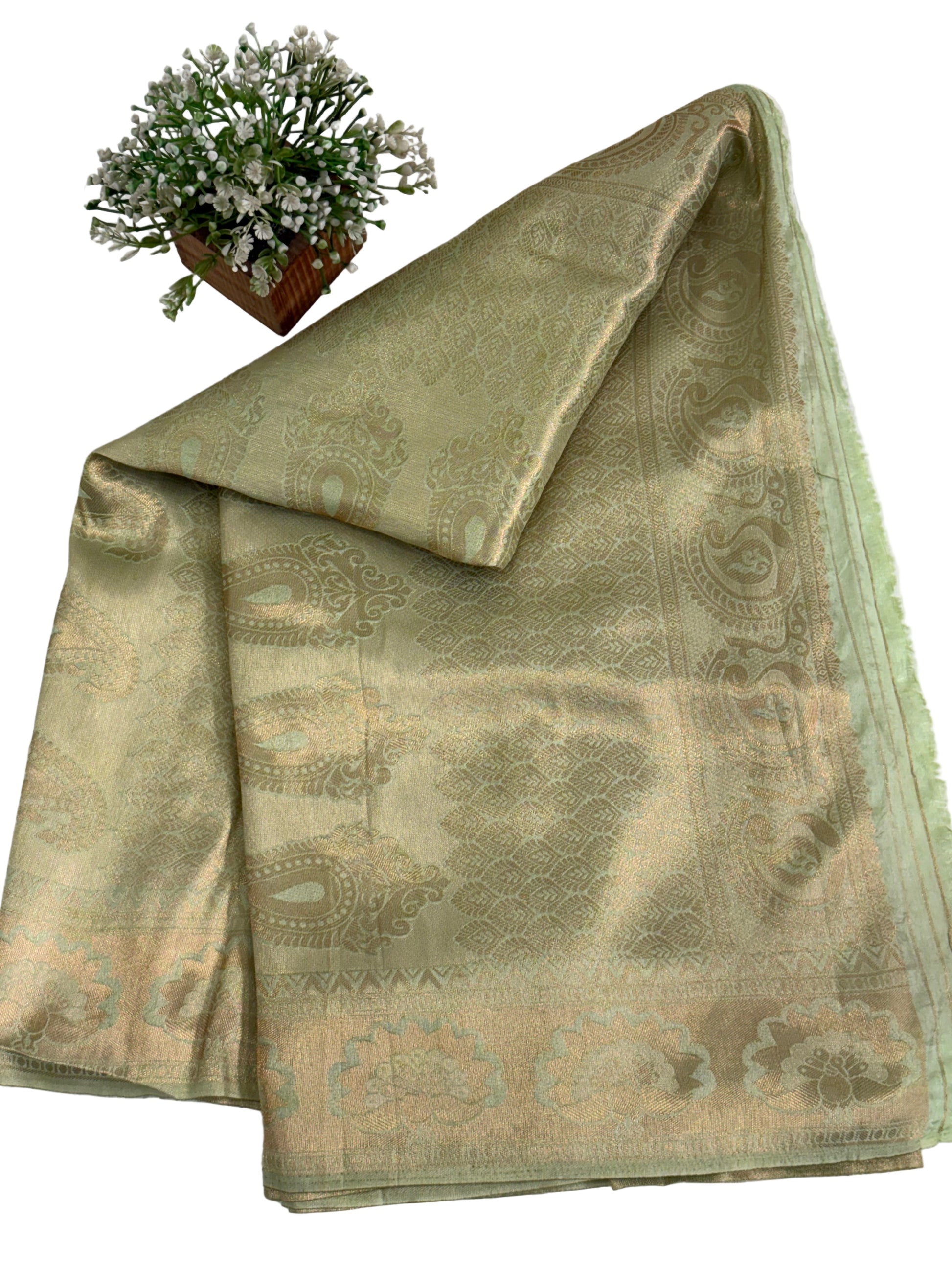 Kanchipuram silk a traditional dual-panel fabric featuring a short-effect. Pista green colour and golden top with woven motifs and a light green  aqua- coloured bottom with woven self-stripes