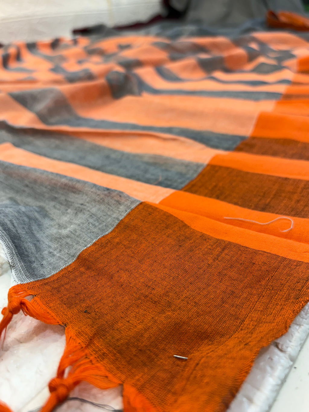 Name: Handwoven Linen Saree cotton Pure linen with dual-tone grey base and peach-grey striped pallu, featuring maroon and rust borders.