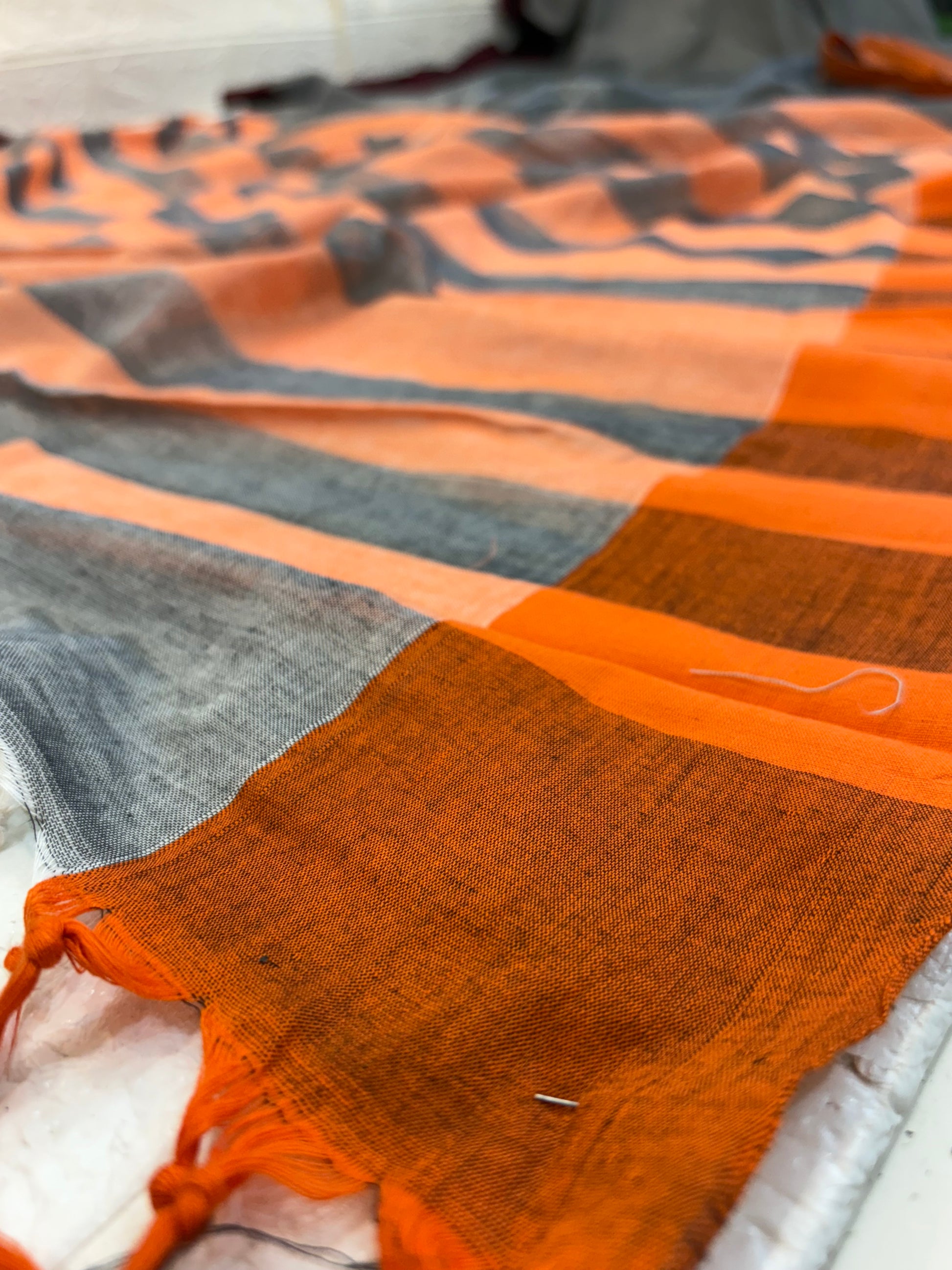 Name: Handwoven Linen Saree cotton Pure linen with dual-tone grey base and peach-grey striped pallu, featuring maroon and rust borders.