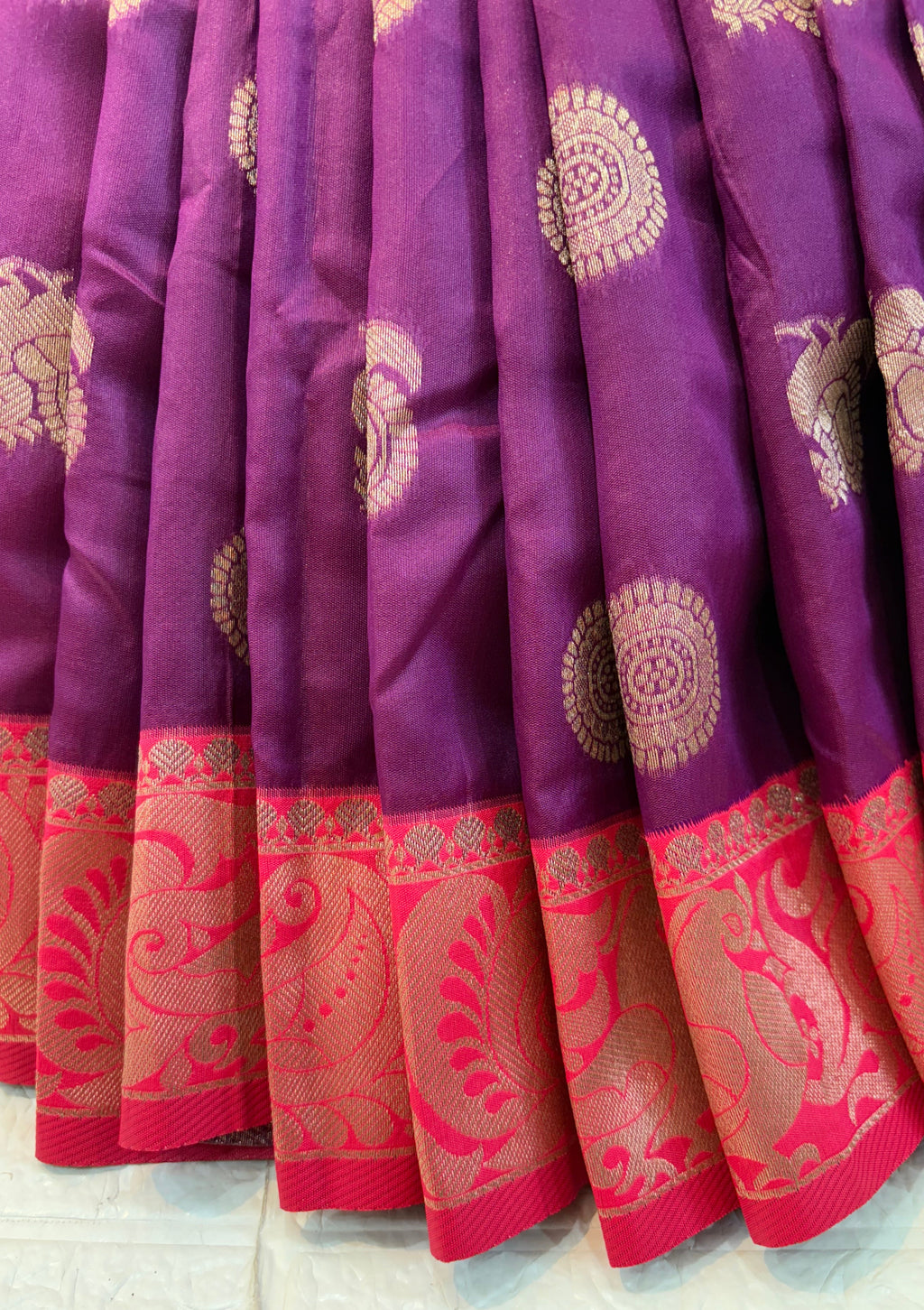 Royal Purple Zari Charm
Luxurious Banarasi silk saree adorned with elegant gold zari butti motifs and a rich contrast zari-woven border, perfect for weddings and festive occasions.