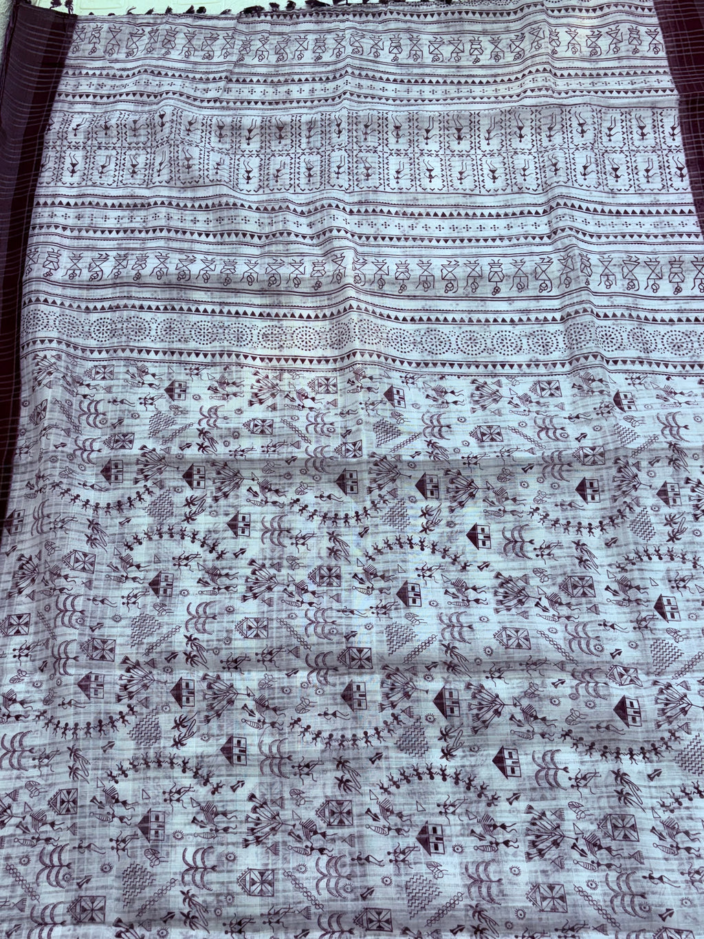 Warli printing on a saree refers to a textile embellished with the traditional tribal art form of the Warli tribe from Maharashtra India The designs cotton fabric and wine colour