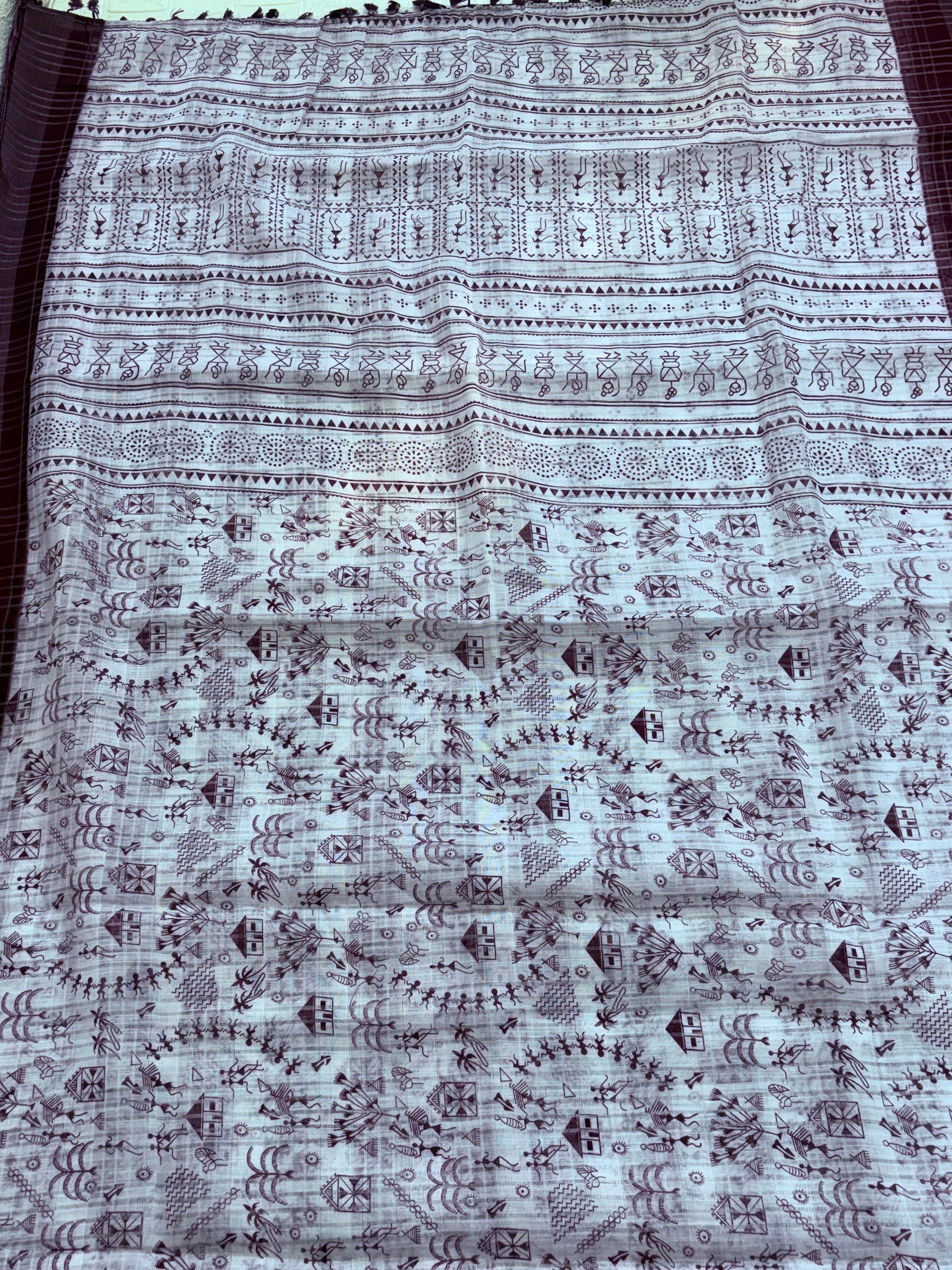 Warli printing on a saree refers to a textile embellished with the traditional tribal art form of the Warli tribe from Maharashtra India The designs cotton fabric and wine colour