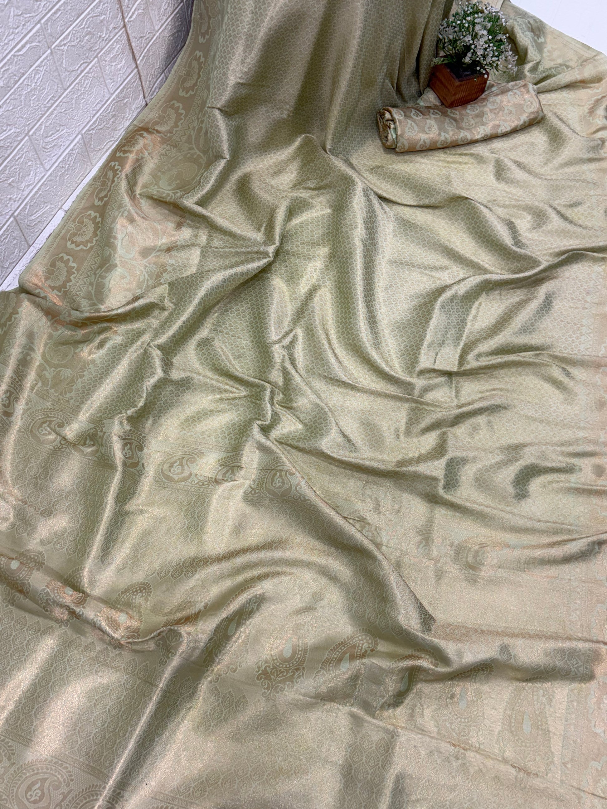 Kanchipuram silk a traditional dual-panel fabric featuring a short-effect. Pista green colour and golden top with woven motifs and a light green  aqua- coloured bottom with woven self-stripes