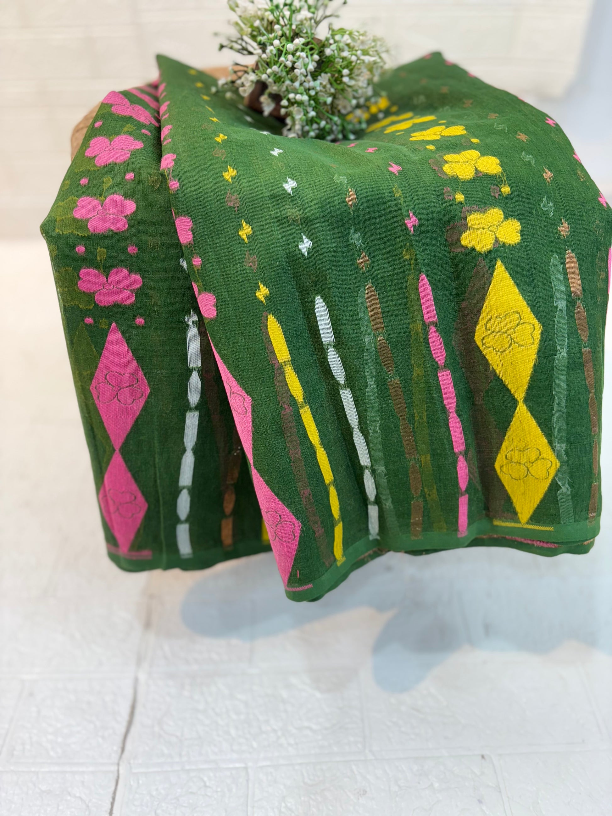 Soft cotton Jamdani, adorned with delicate floral motifs and a traditional woven border, light and breathable for all-day elegan